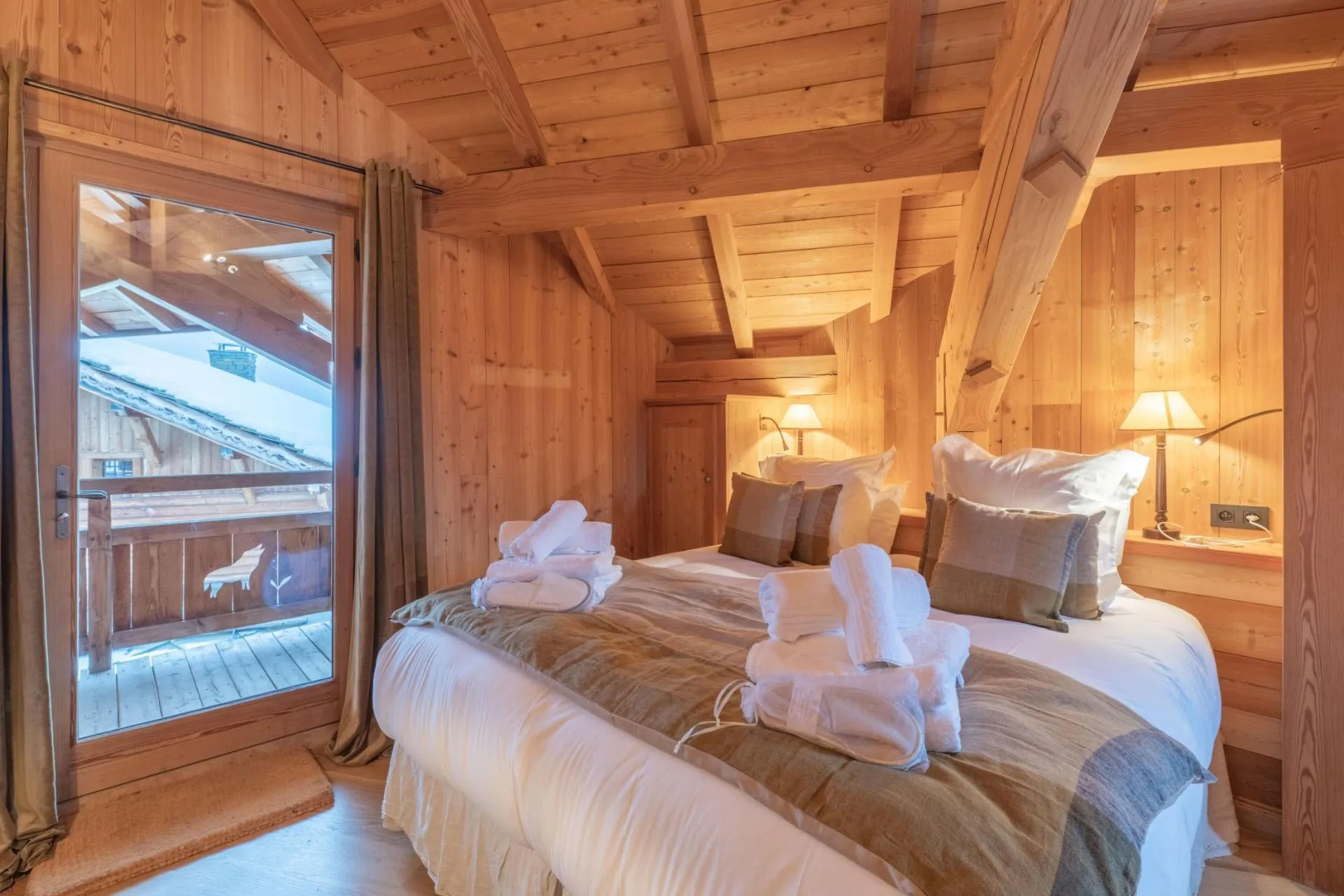 Double bedroom with a timber-lined ceiling and balcony access