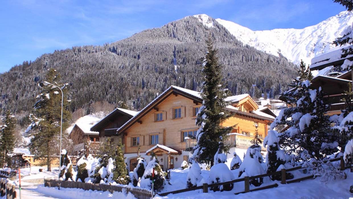Chalet exterior with timber facade and mountain backdrop