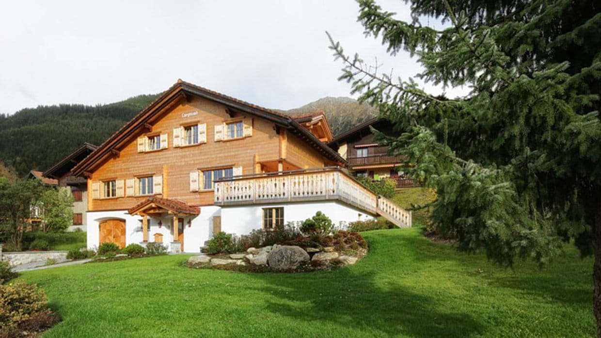 Chalet exterior with wrap-around sun deck and private garden lawn