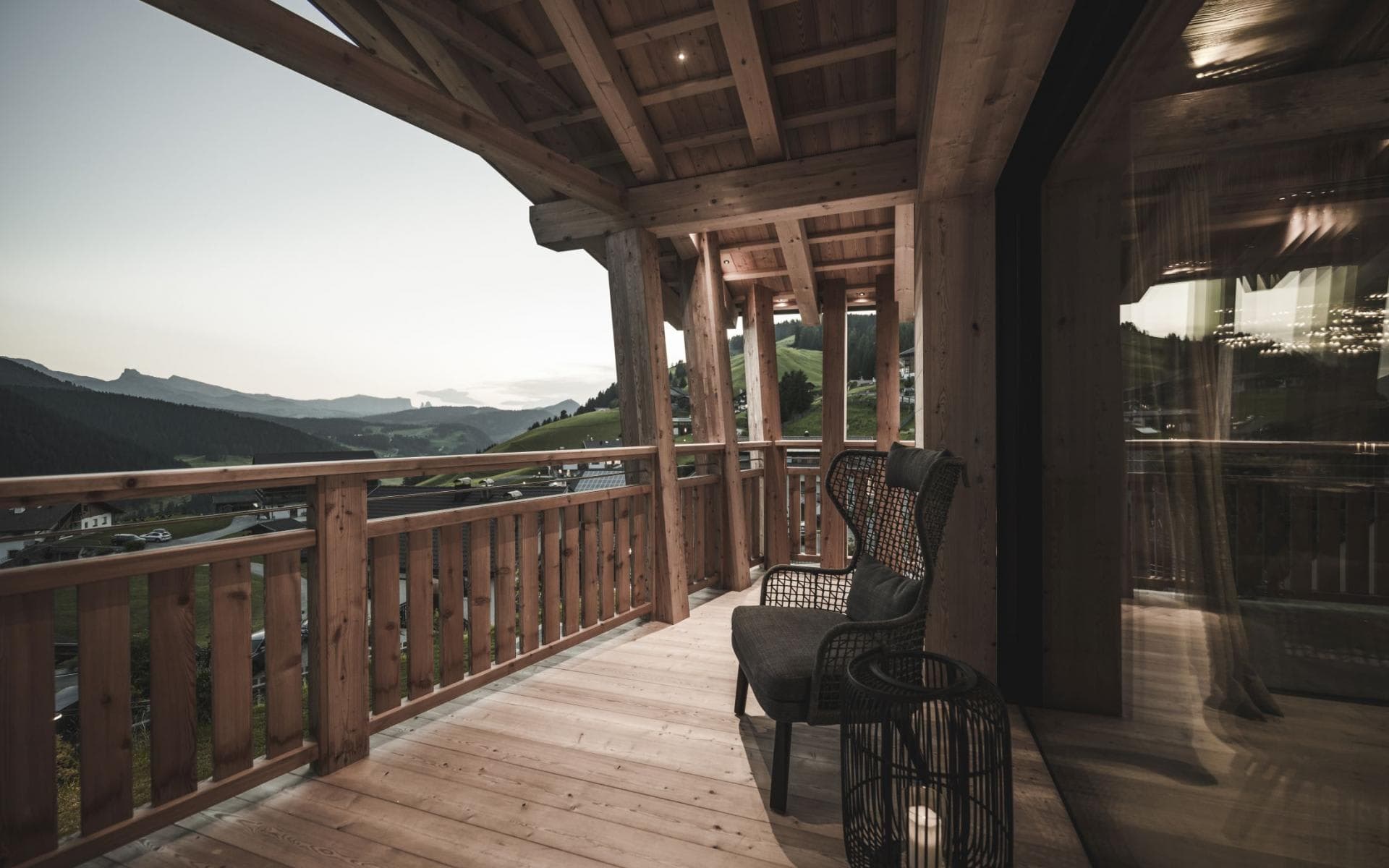 Covered timber balcony with valley views and high-back seating
