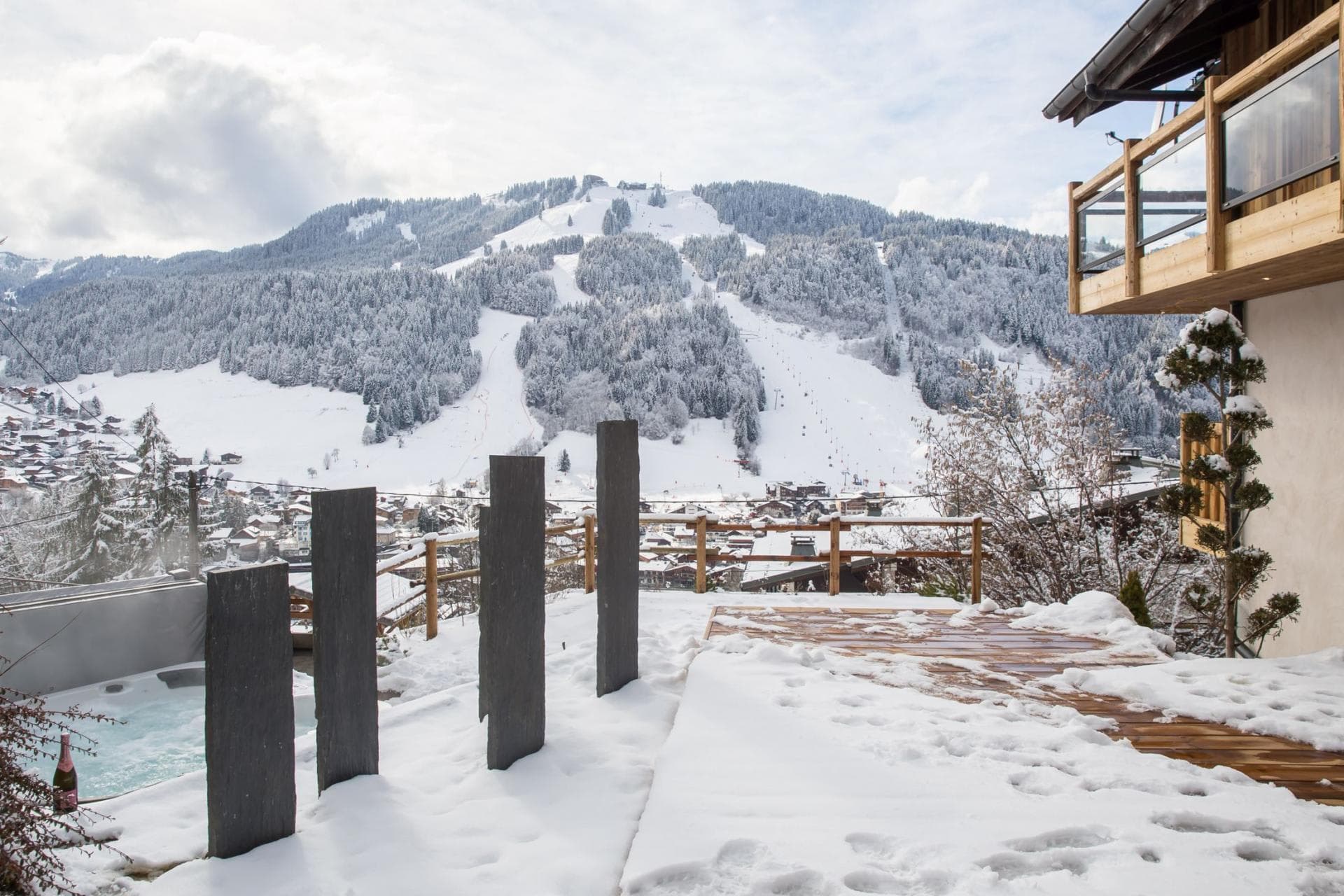 Outdoor terrace with hot tub and panoramic ski slope views