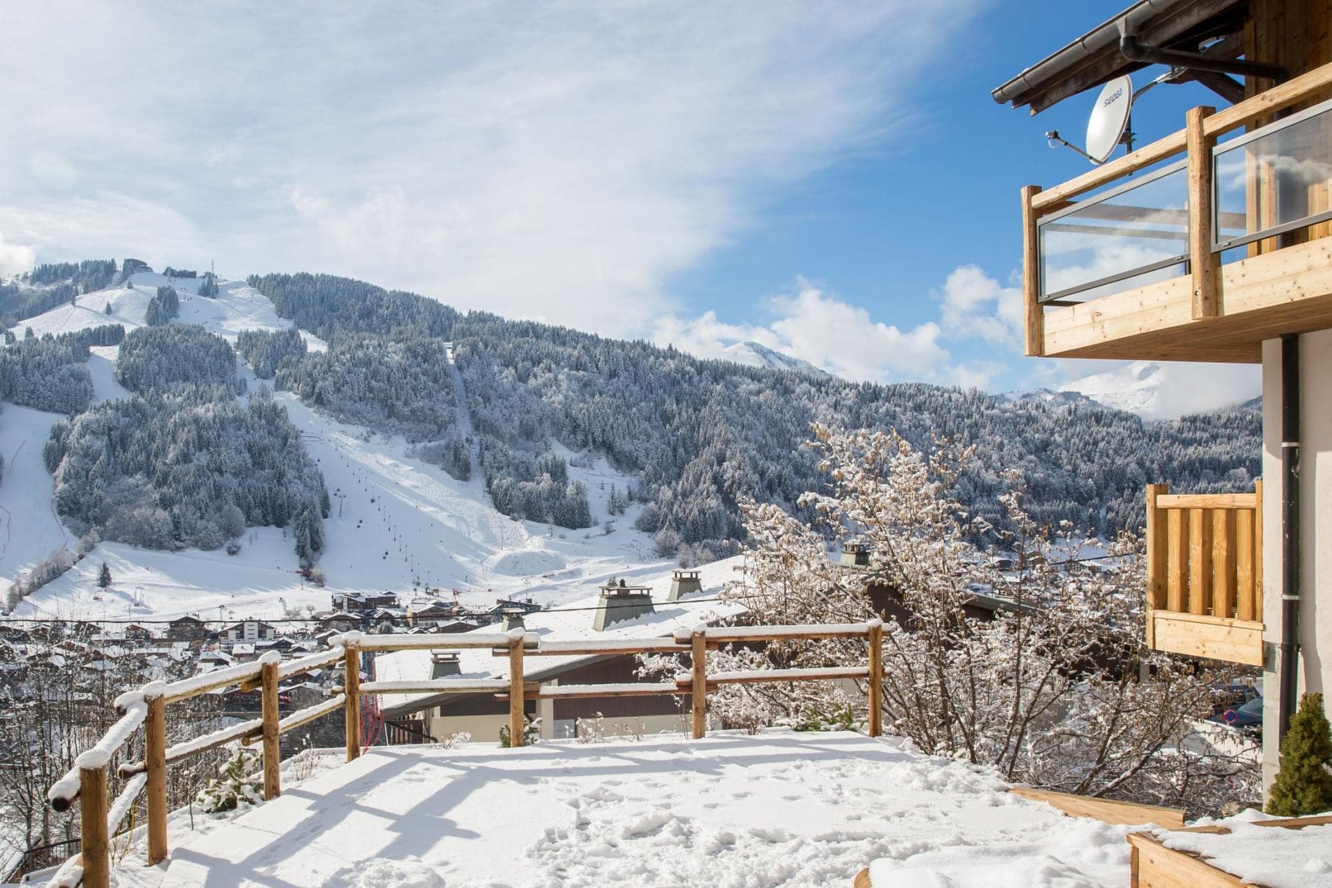 Snow-covered terrace with views of the village and ski slopes
