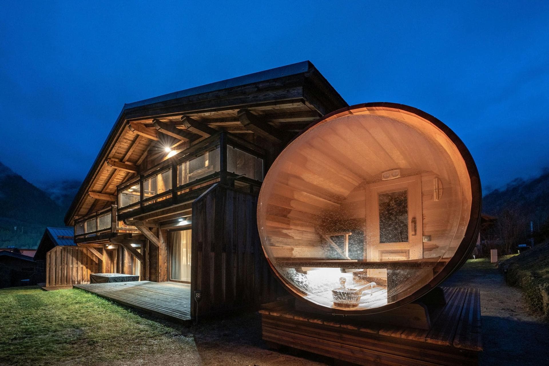 Outdoor barrel sauna with panoramic glass wall and cedar interior
