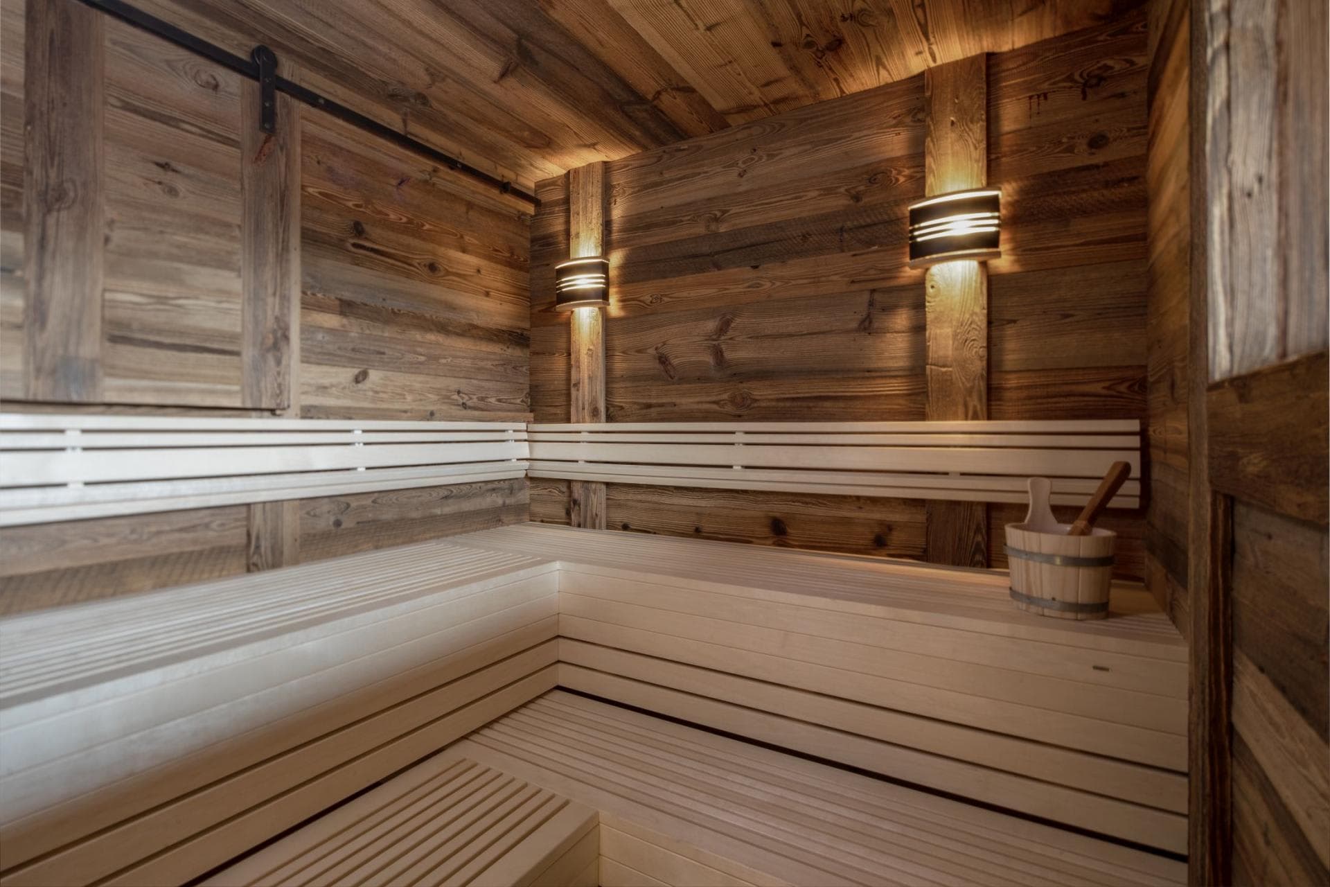 Sauna with two-tier seating and reclaimed wood walls
