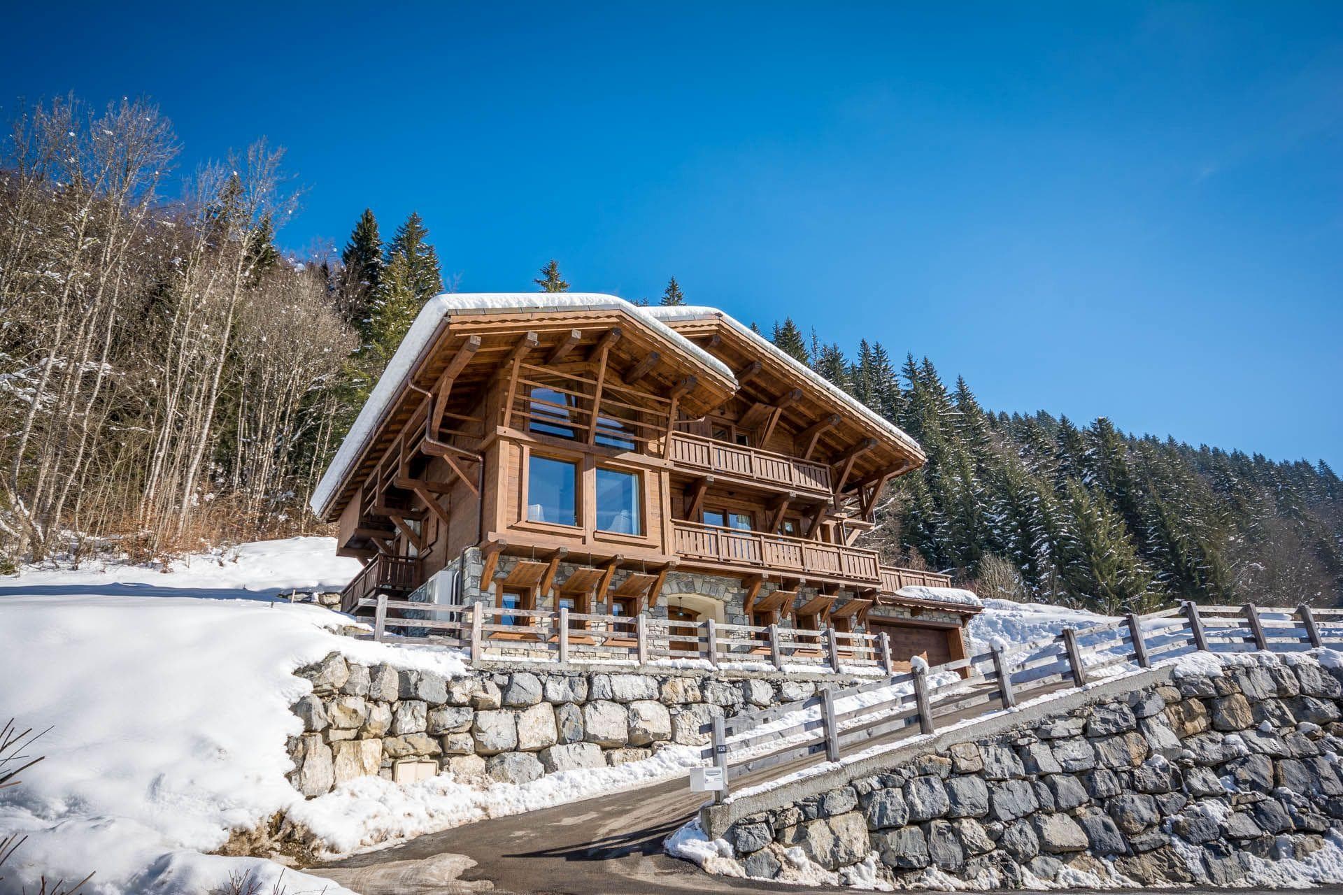 Ski-in chalet exterior with heated driveway and two-car garage