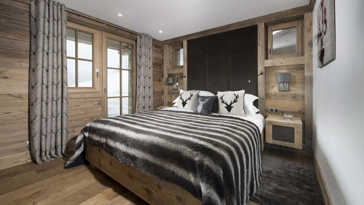 Bedroom with king bed and direct terrace access to snowy slopes