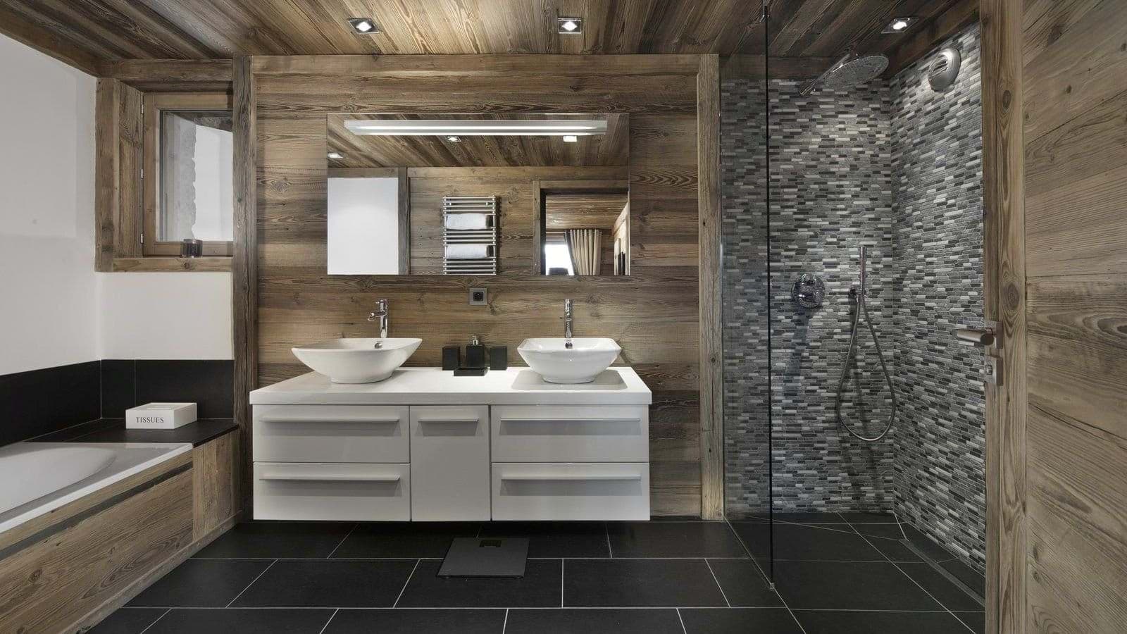 Bathroom with dual vanity, soaking tub, and walk-in rainfall shower