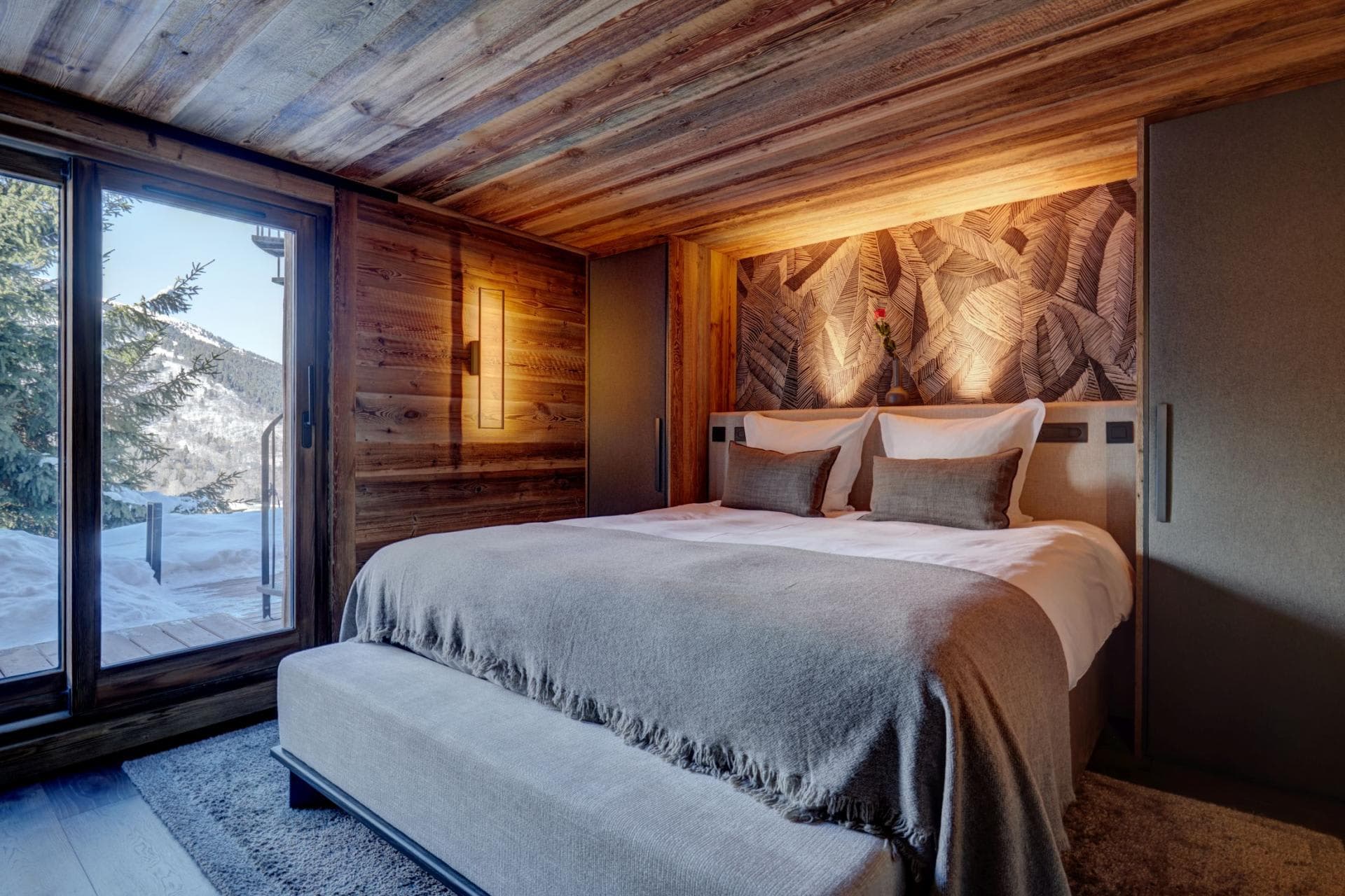 Bedroom with king bed and balcony access to mountain views