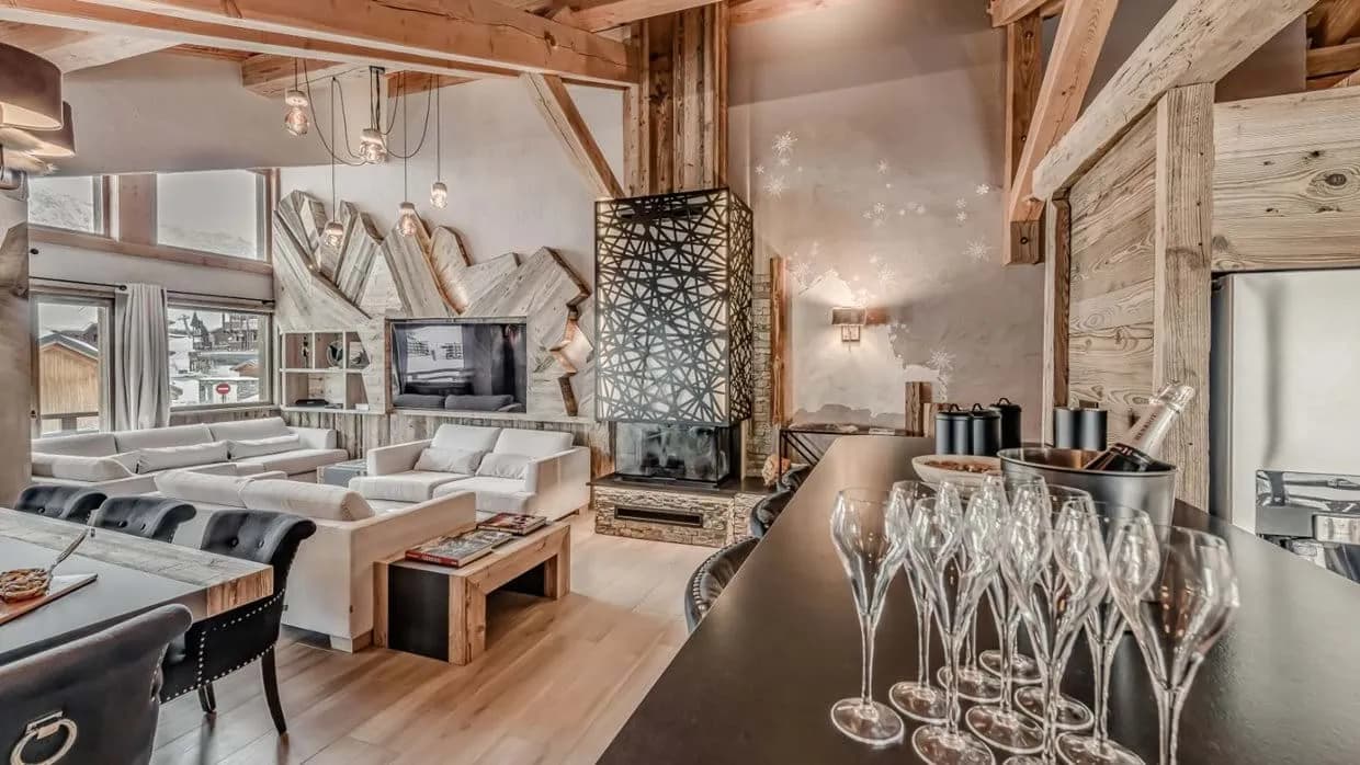 Open-plan living area with timber beams and wood-burning fireplace