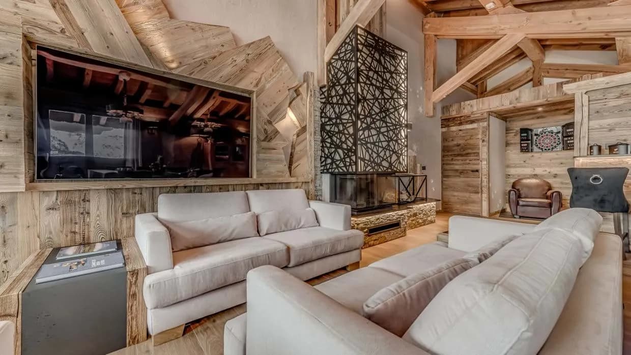Living area with vaulted timber ceilings and custom geometric fireplace screen