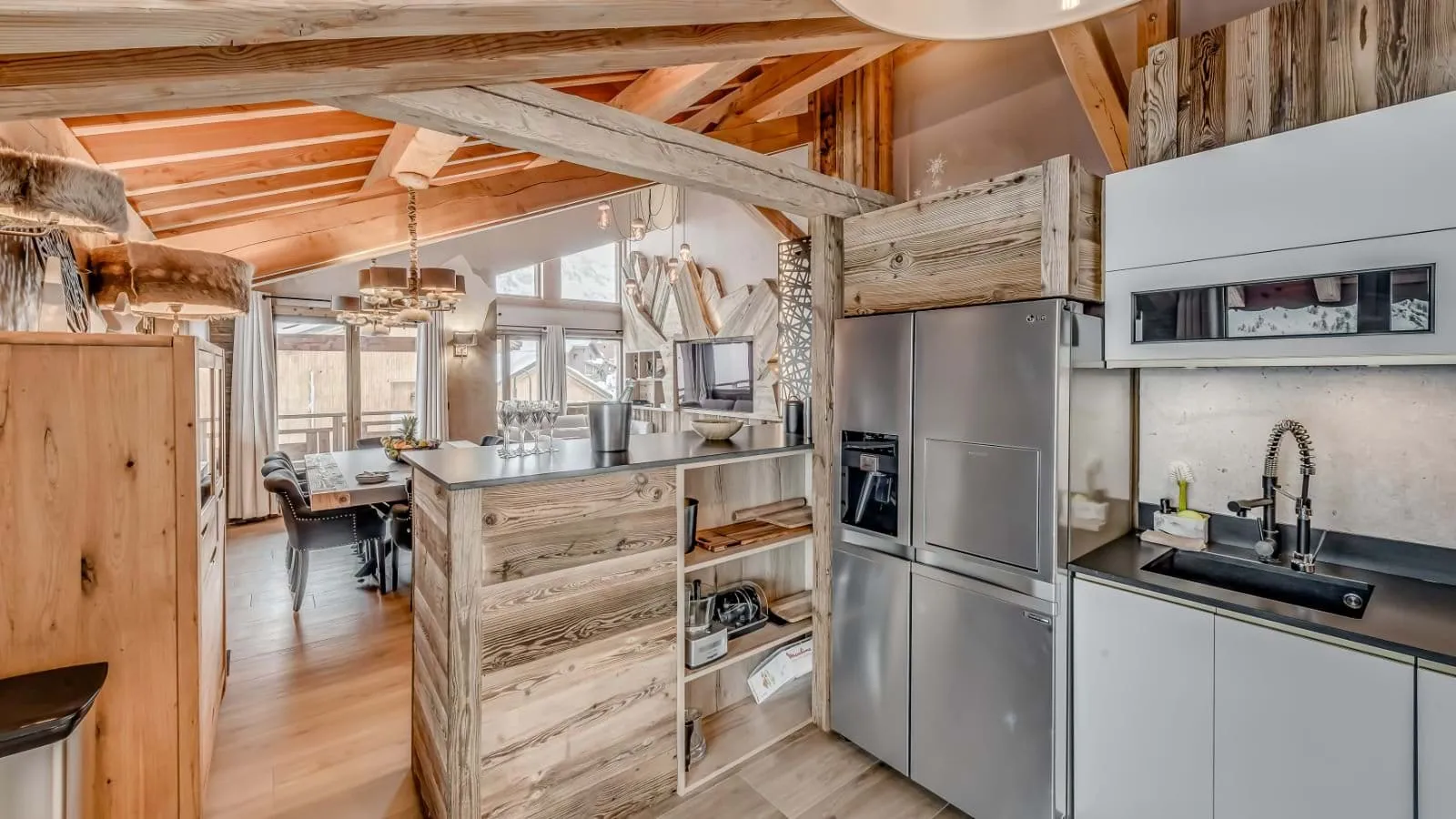 Kitchen with LG side-by-side refrigerator and wood-paneled breakfast bar