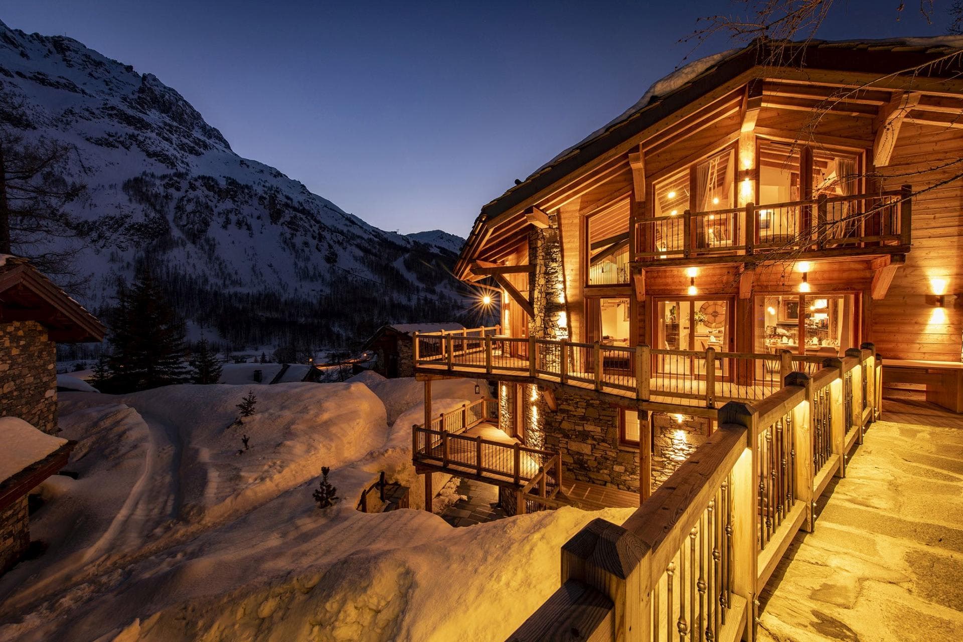 Ski chalet exterior with wrap-around balconies and mountain views