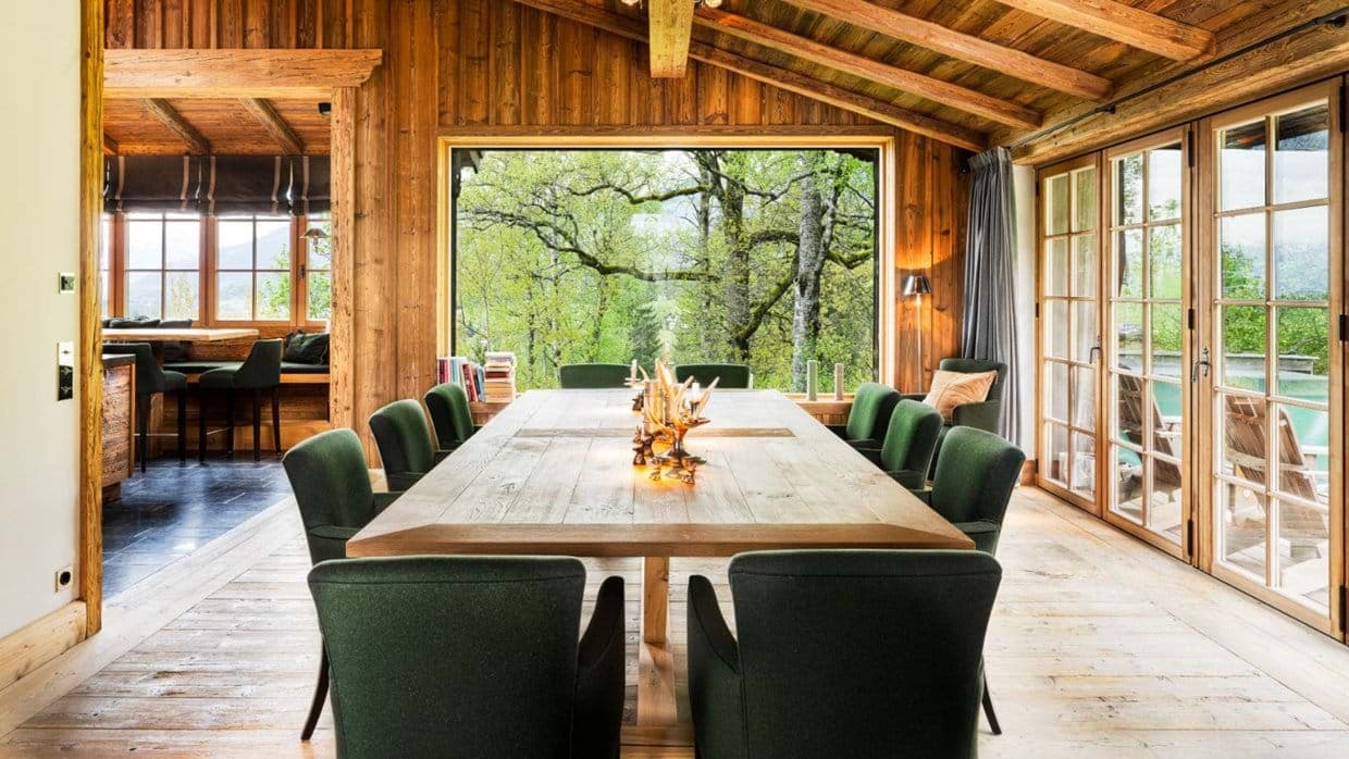 Dining table seats 10 with forest views and terrace access