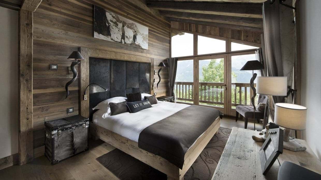 Primary bedroom with king bed and mountain-view balcony access