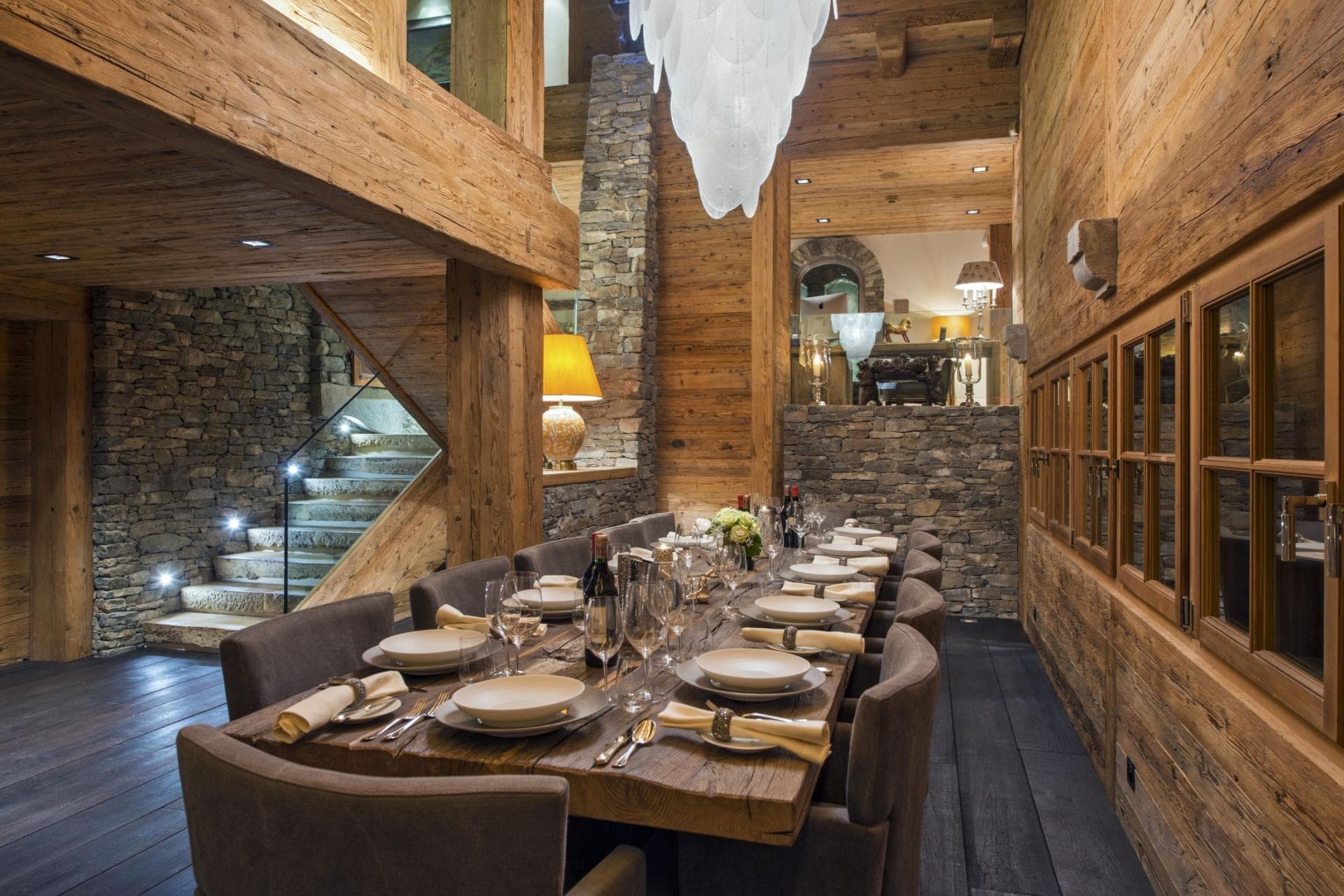 Dining area with seating for 12 adjacent to lit stone staircase