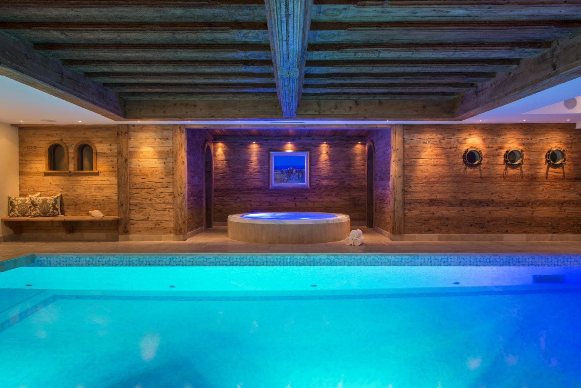 Indoor pool and circular hot tub with reclaimed wood paneling
