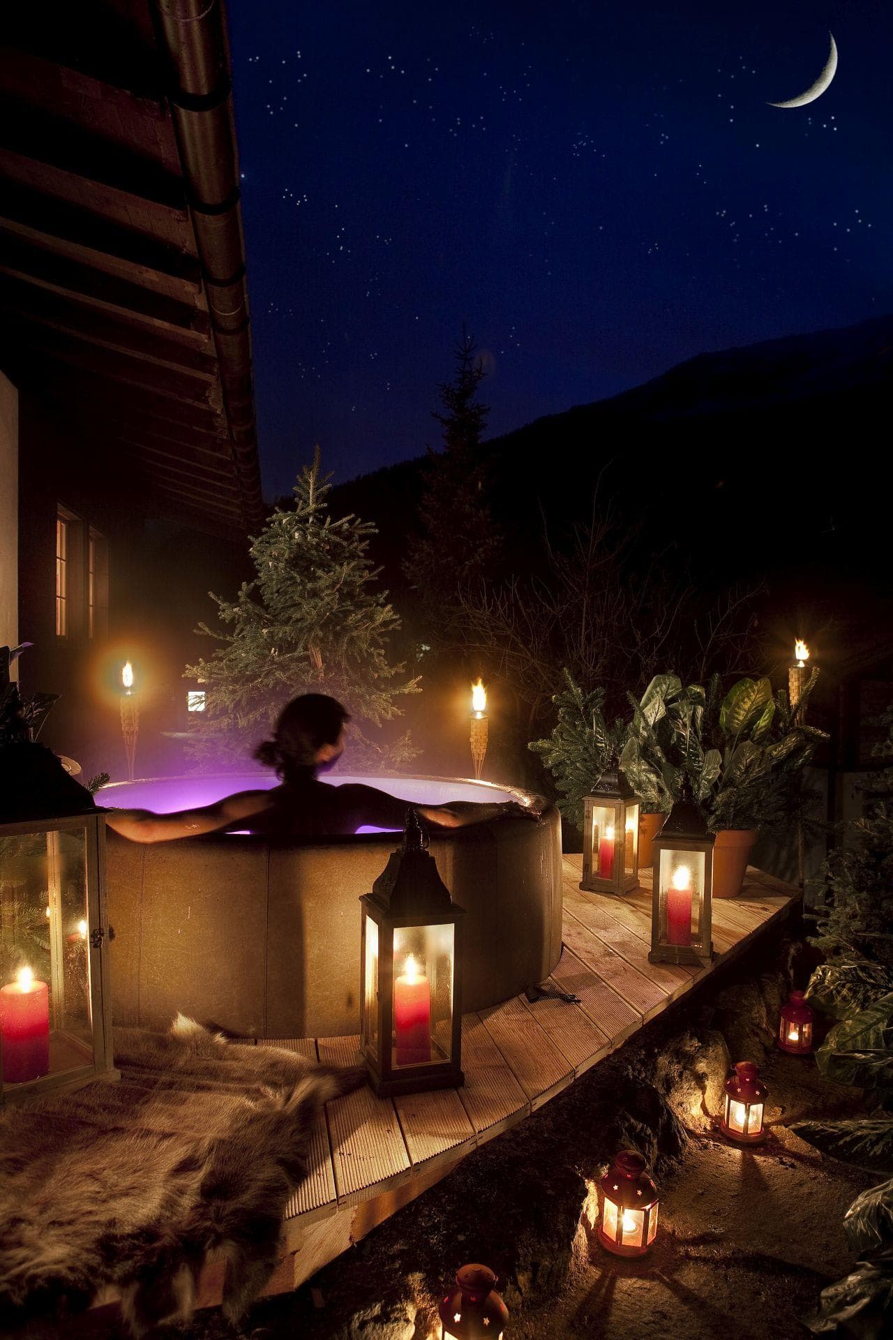 Circular outdoor hot tub on private deck with mountain views