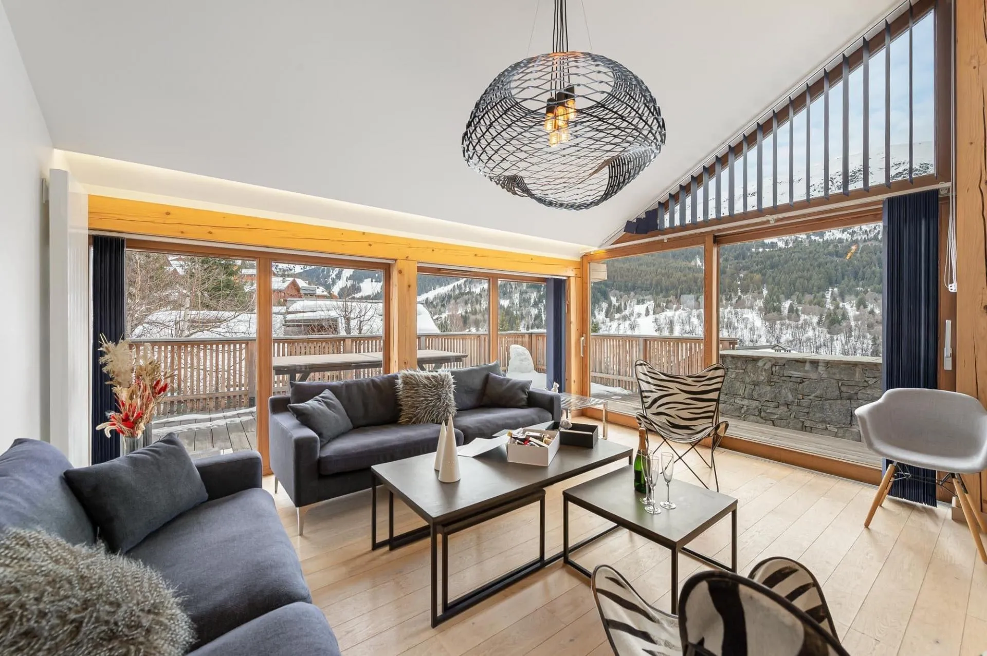 Living room with floor-to-ceiling windows and mountain-view balcony access