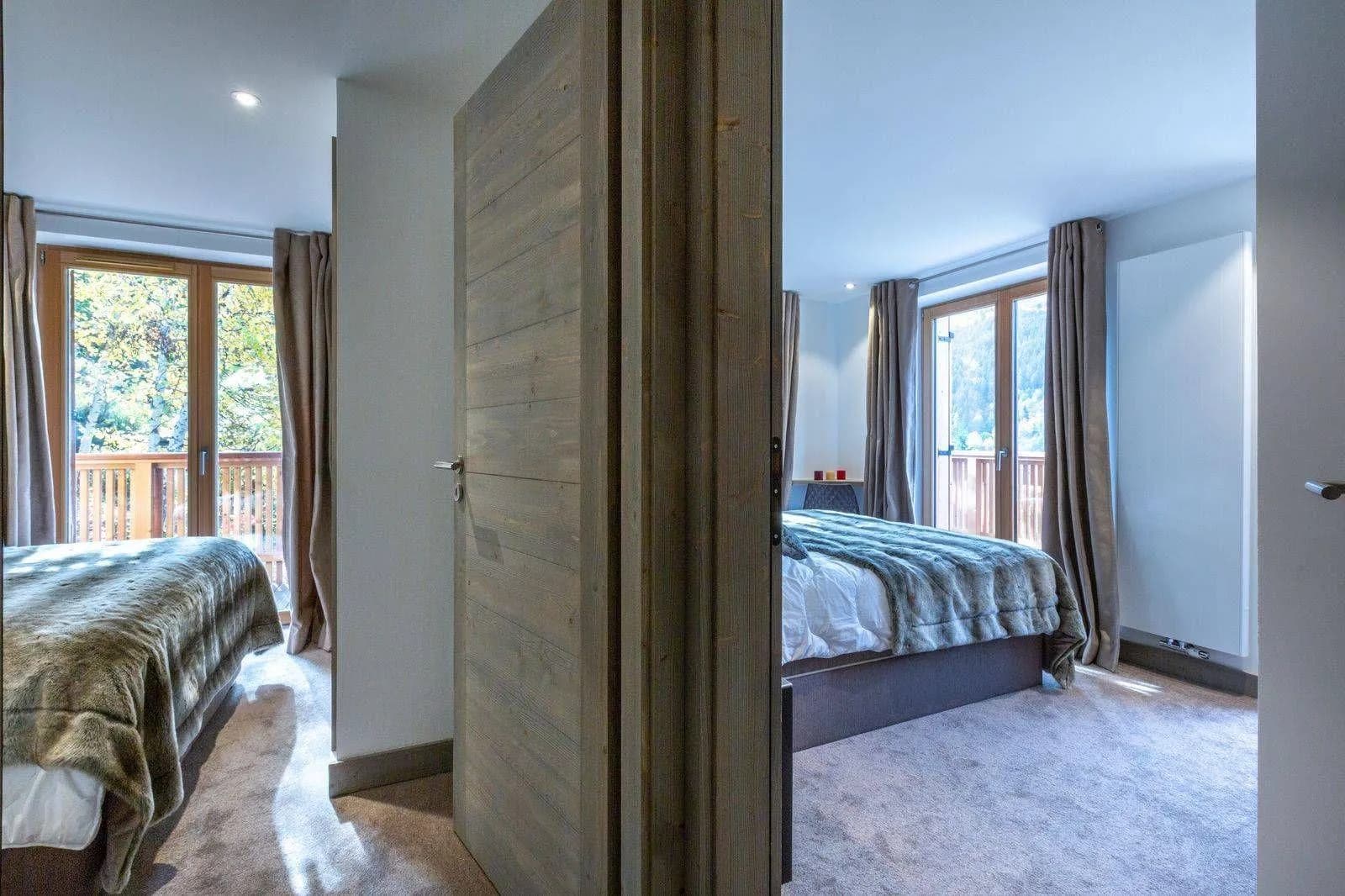 Adjacent bedrooms with floor-to-ceiling windows and balcony access