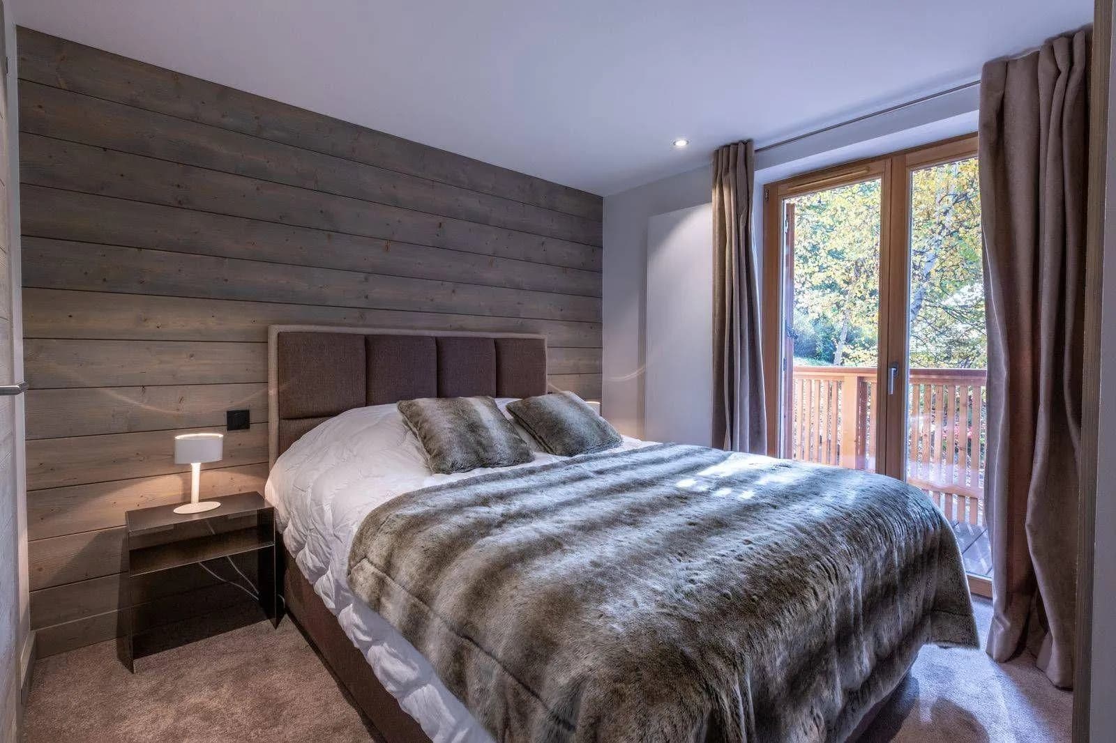 Bedroom with king bed and glass door to balcony
