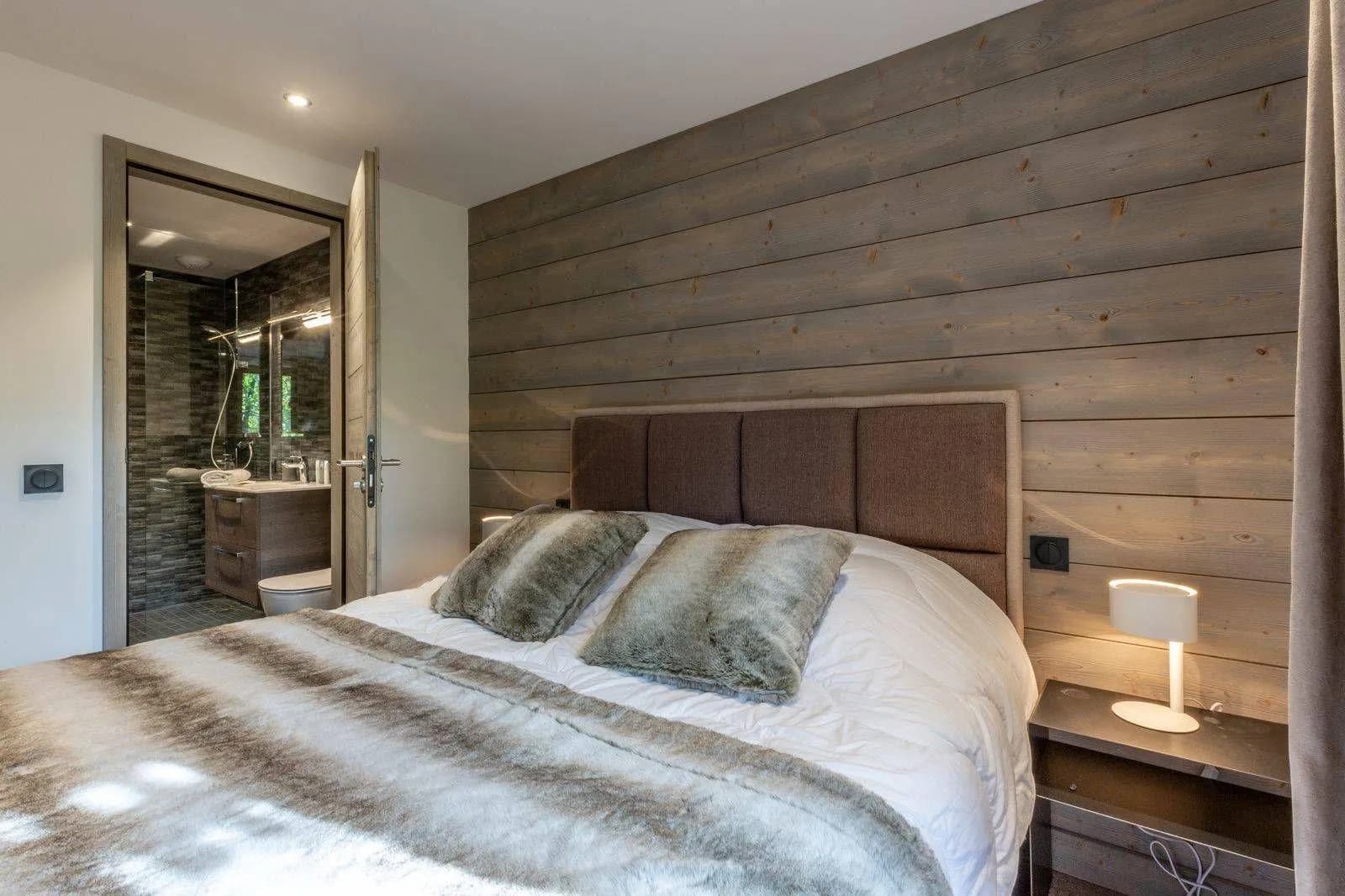 Bedroom with king bed and ensuite featuring walk-in shower
