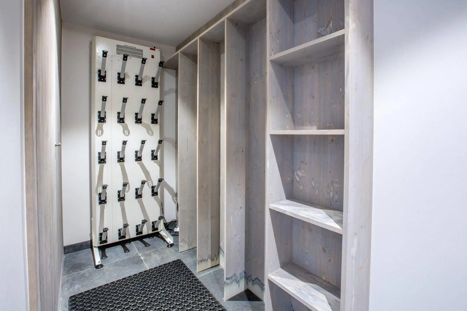 Ski storage room with heated boot rack and built-in shelving