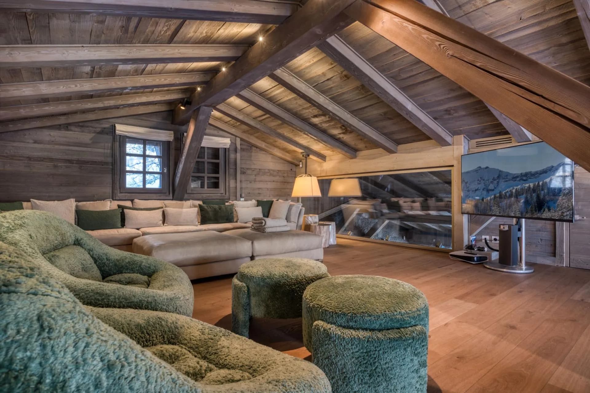 Loft media room with timber beams and glass floor overlooking lower level