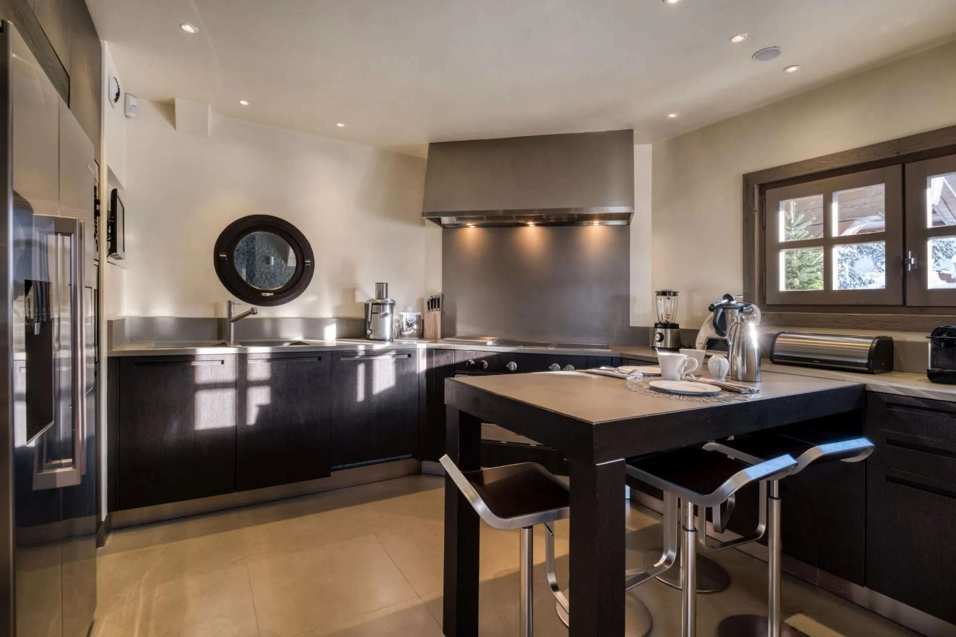Kitchen with island seating for 3 and stainless steel appliances