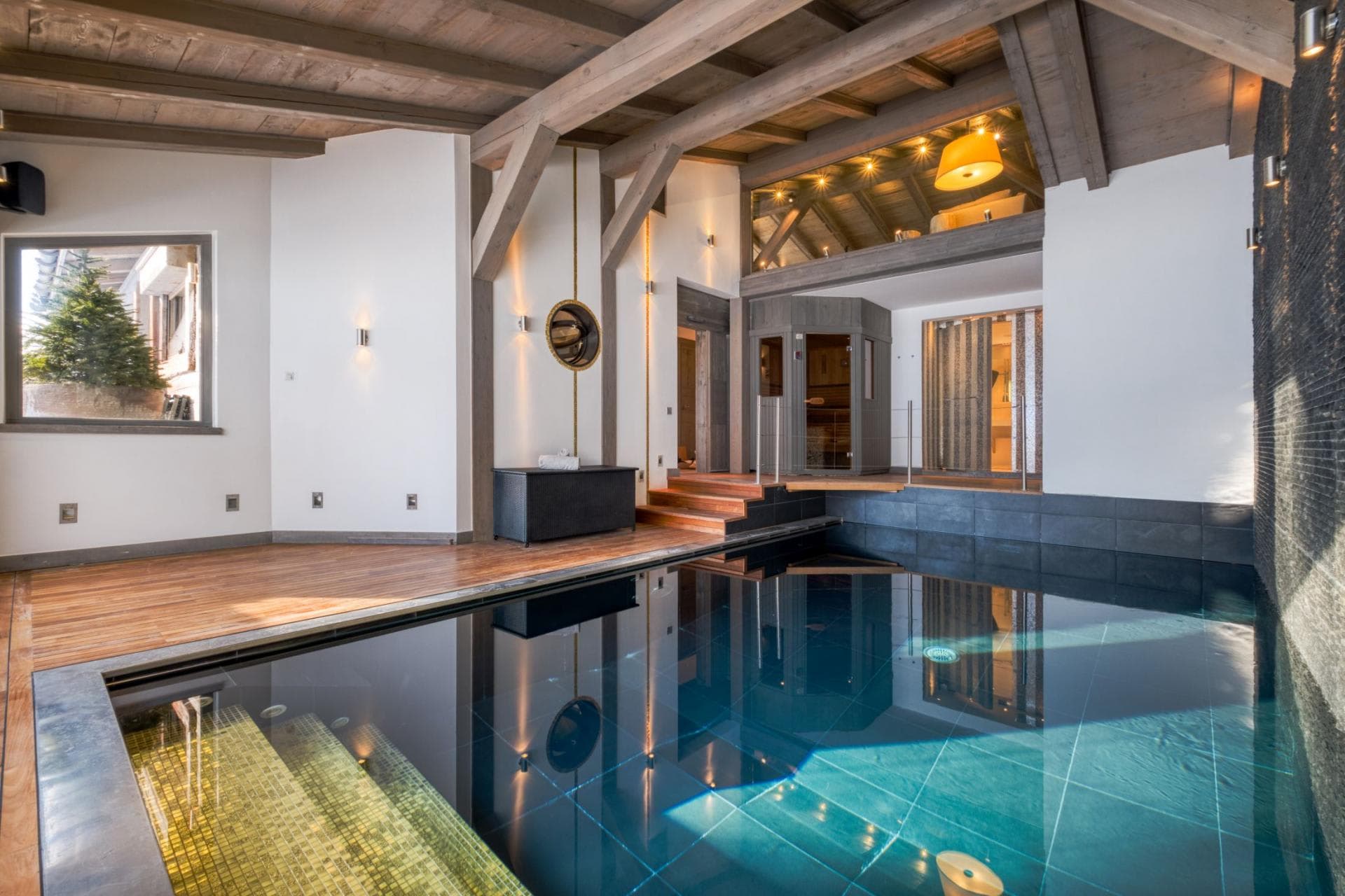 Indoor pool with integrated sauna and mezzanine seating area