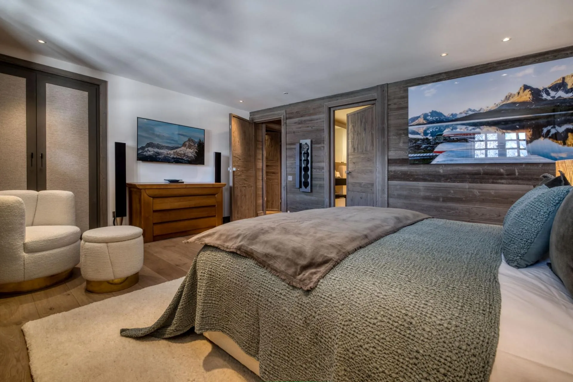 Primary bedroom with wall-mounted TV and ensuite bathroom access