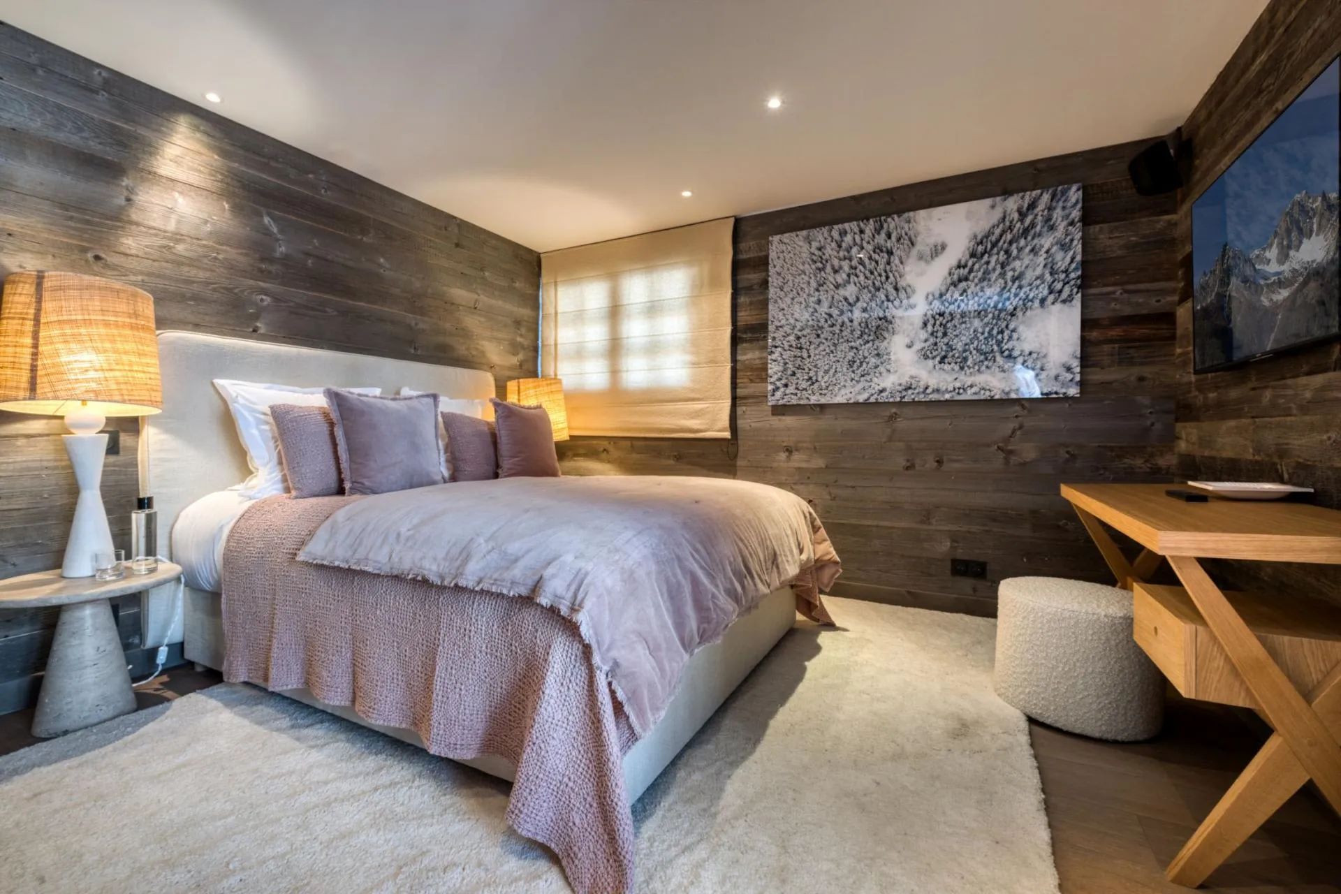 Guest bedroom with king bed, reclaimed wood walls, and work desk
