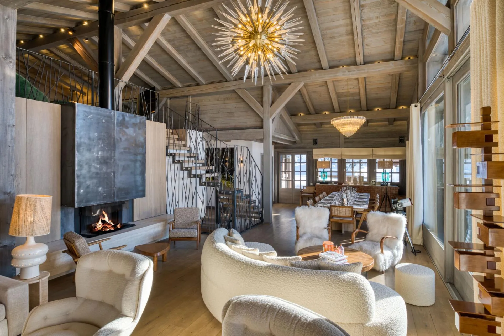 Open-plan living area with wood-burning fireplace and dining seating for 10
