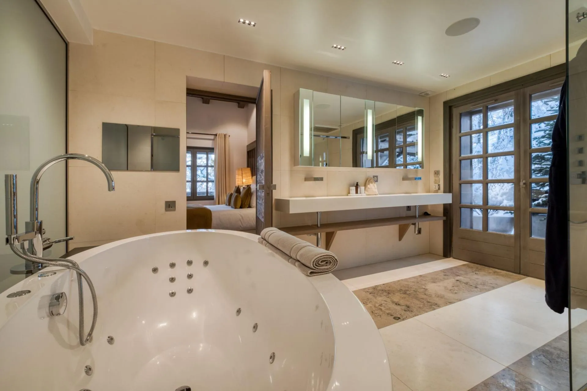 En suite bathroom with jetted soaking tub and dual vanity
