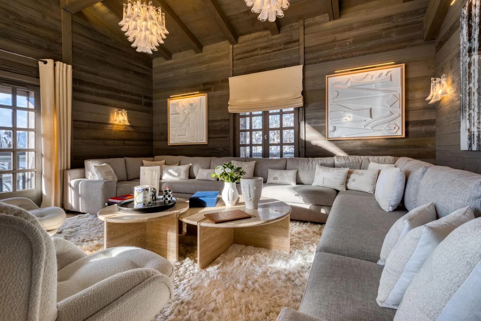 Living area with wrap-around sectional seating for 10 and wood-paneled walls