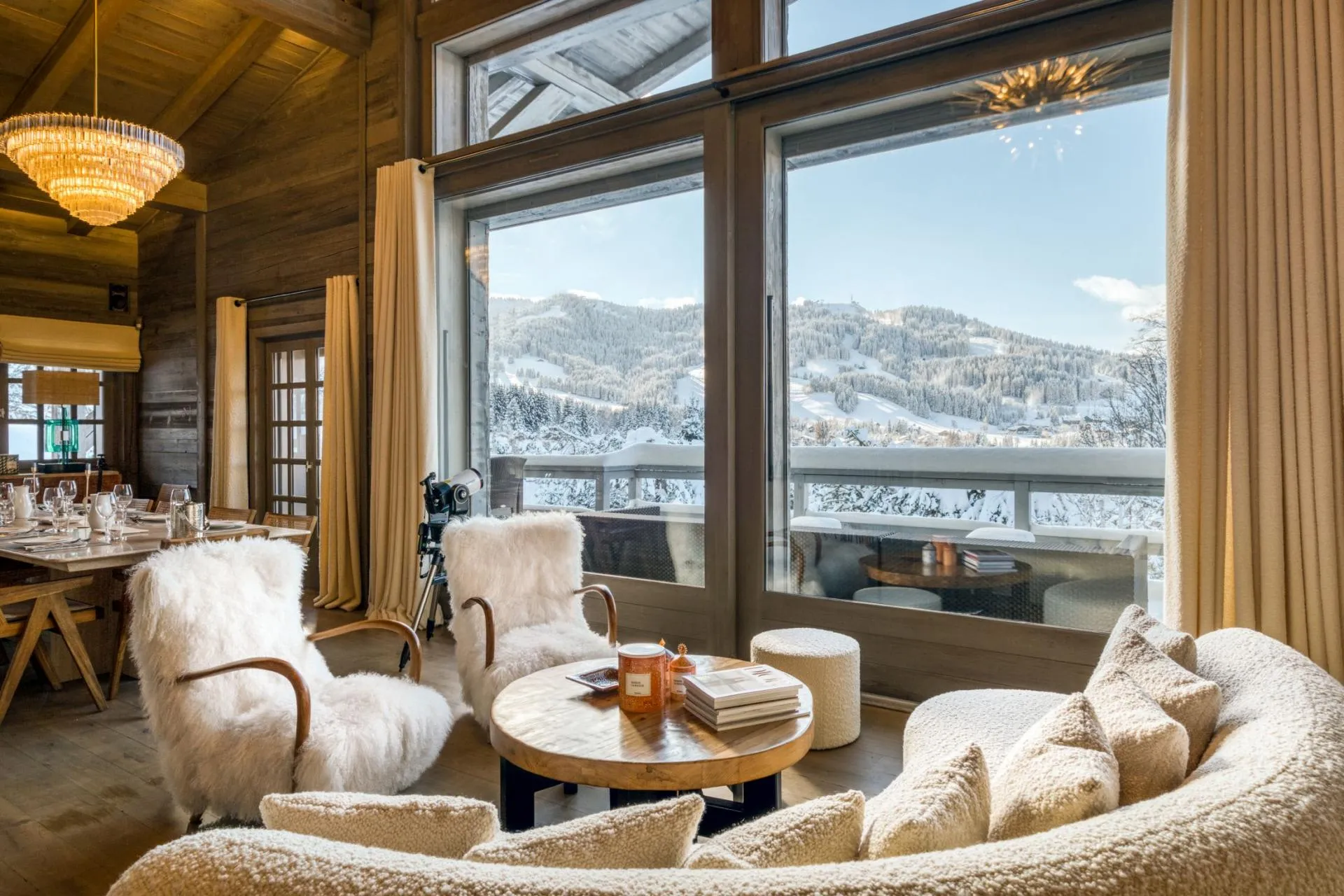 Open-plan living area with floor-to-ceiling mountain views and telescope