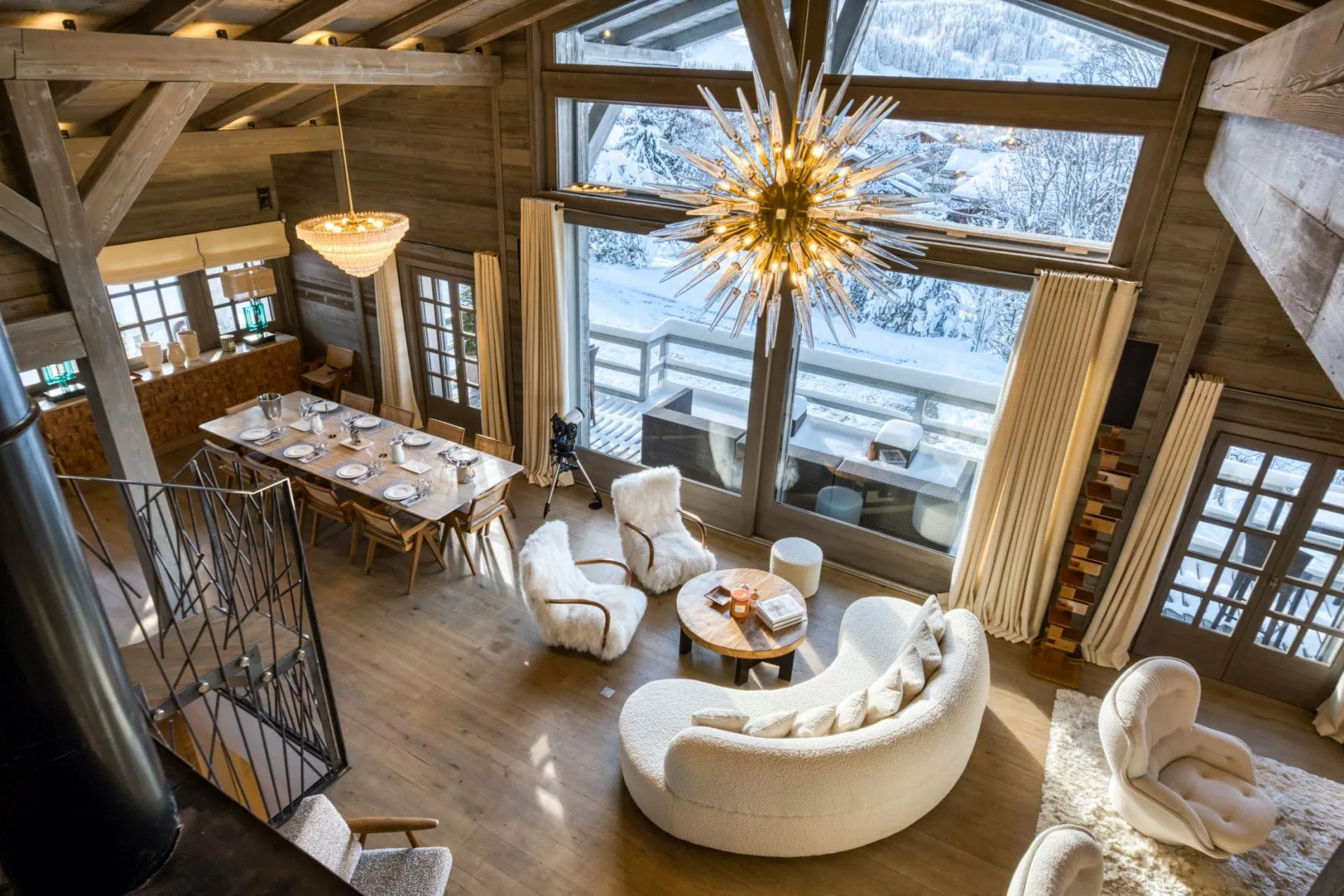 Open-plan living area with vaulted ceilings and floor-to-ceiling mountain views
