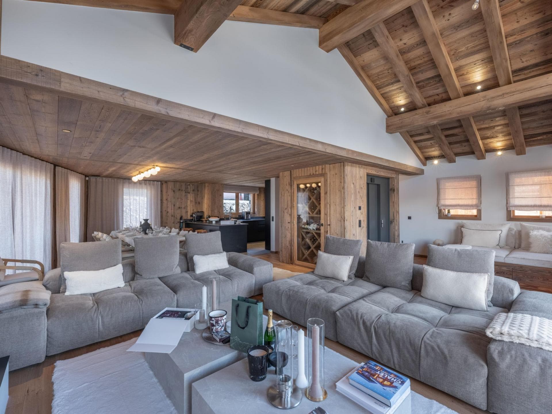 Open-plan living area with vaulted timber ceilings and temperature-controlled wine cellar