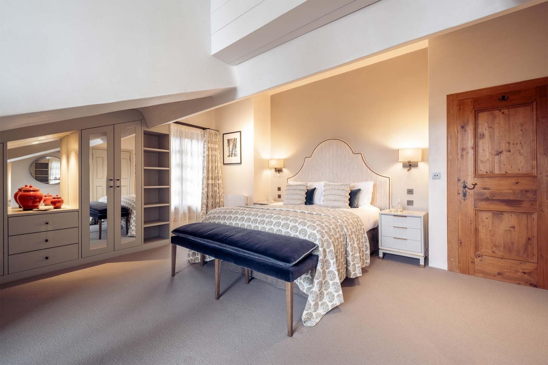 Primary bedroom with king bed and custom built-in wardrobe storage