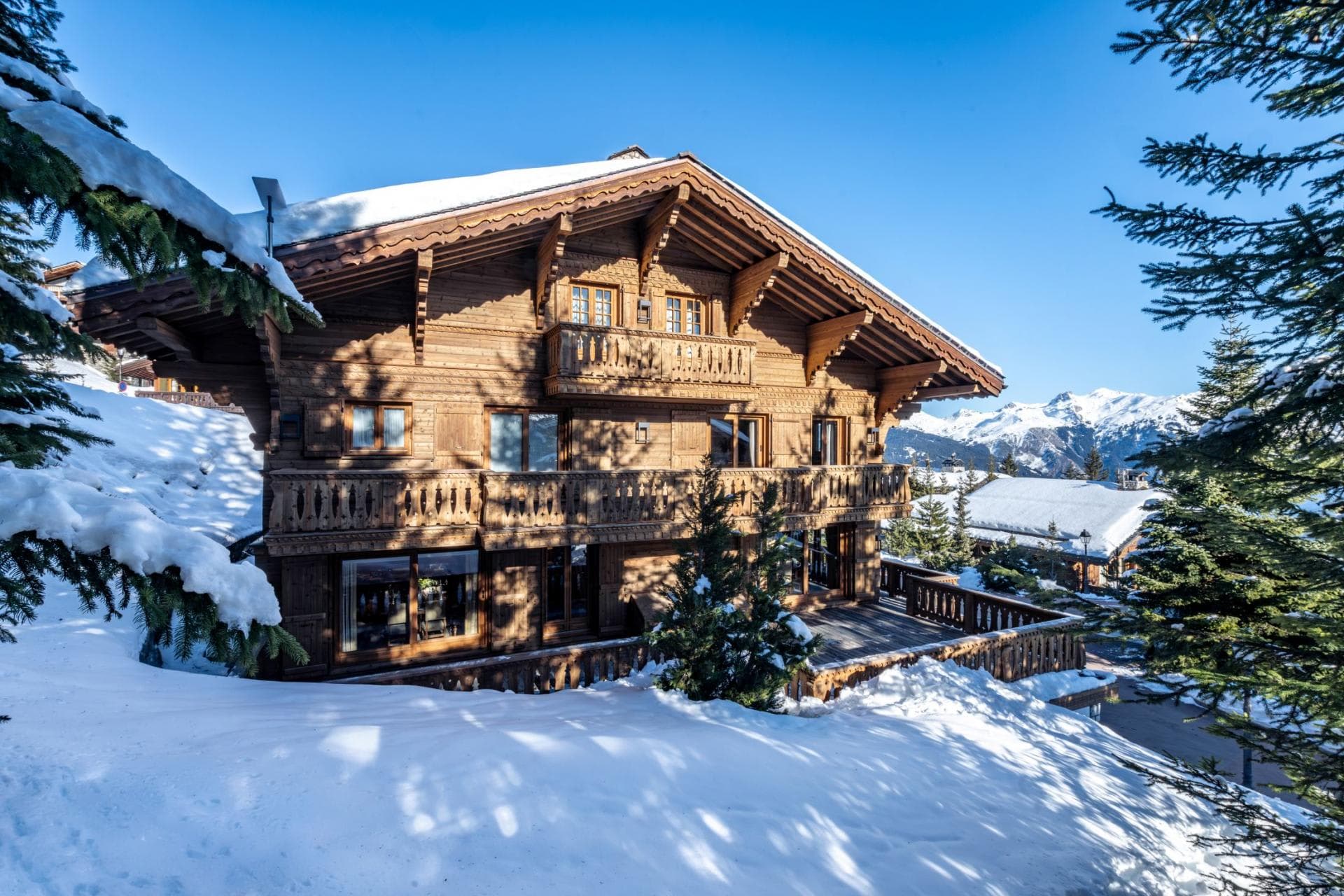Ski-in chalet with wrap-around sun deck and carved timber balconies