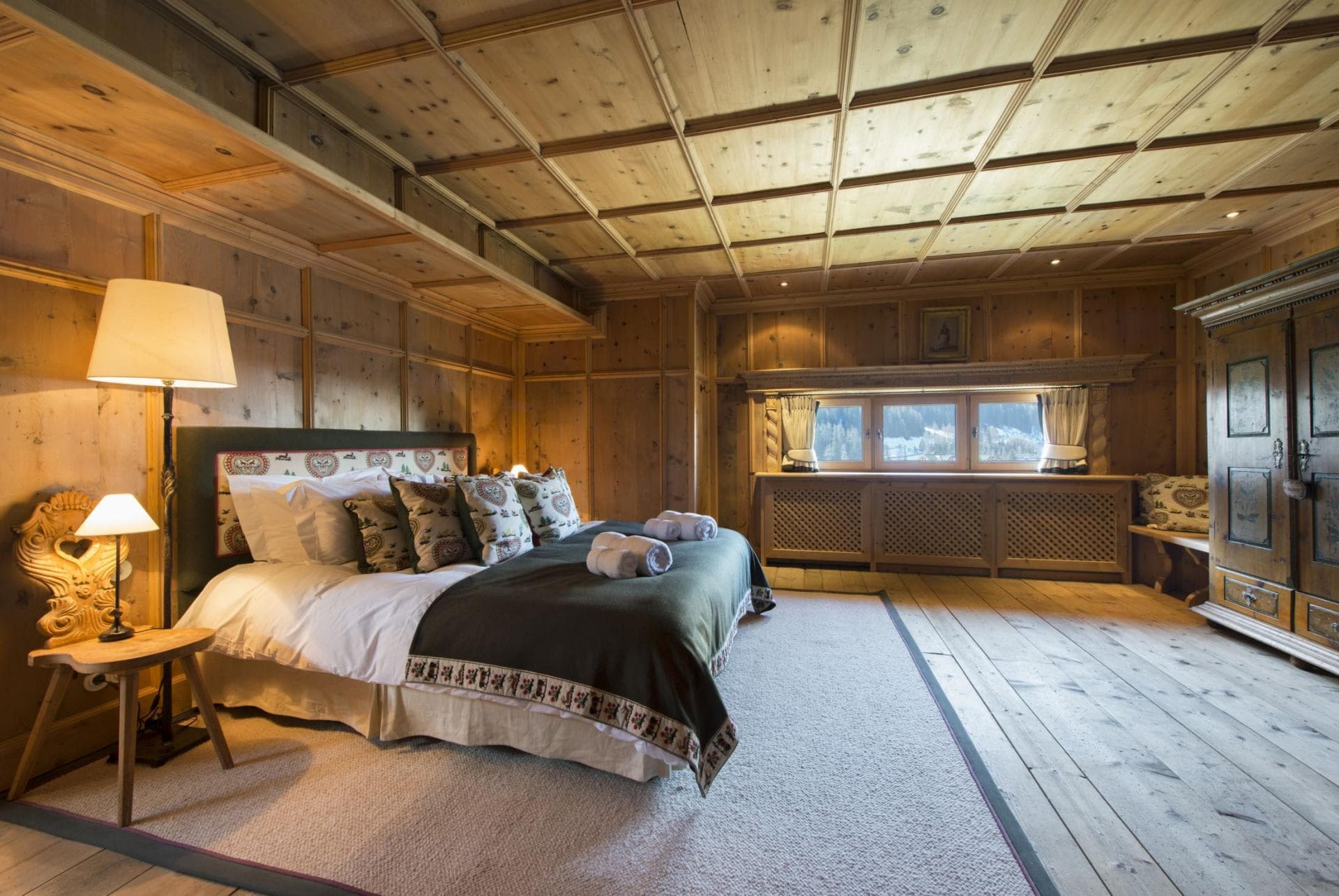 Guest bedroom with king bed and original wood paneling