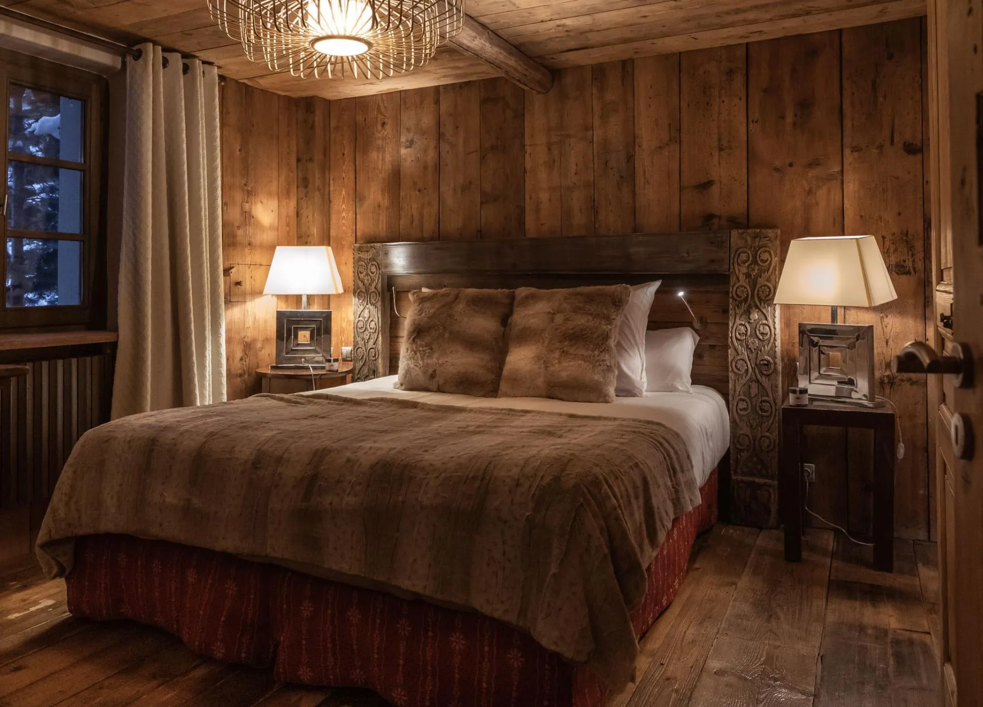 Double bedroom with timber wall panels and bedside tables