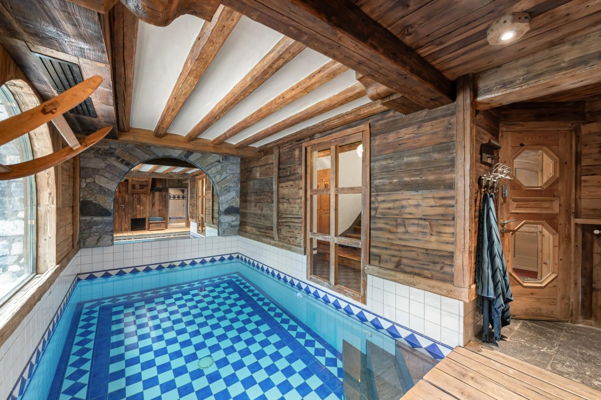 Indoor swimming pool beneath exposed timber beams