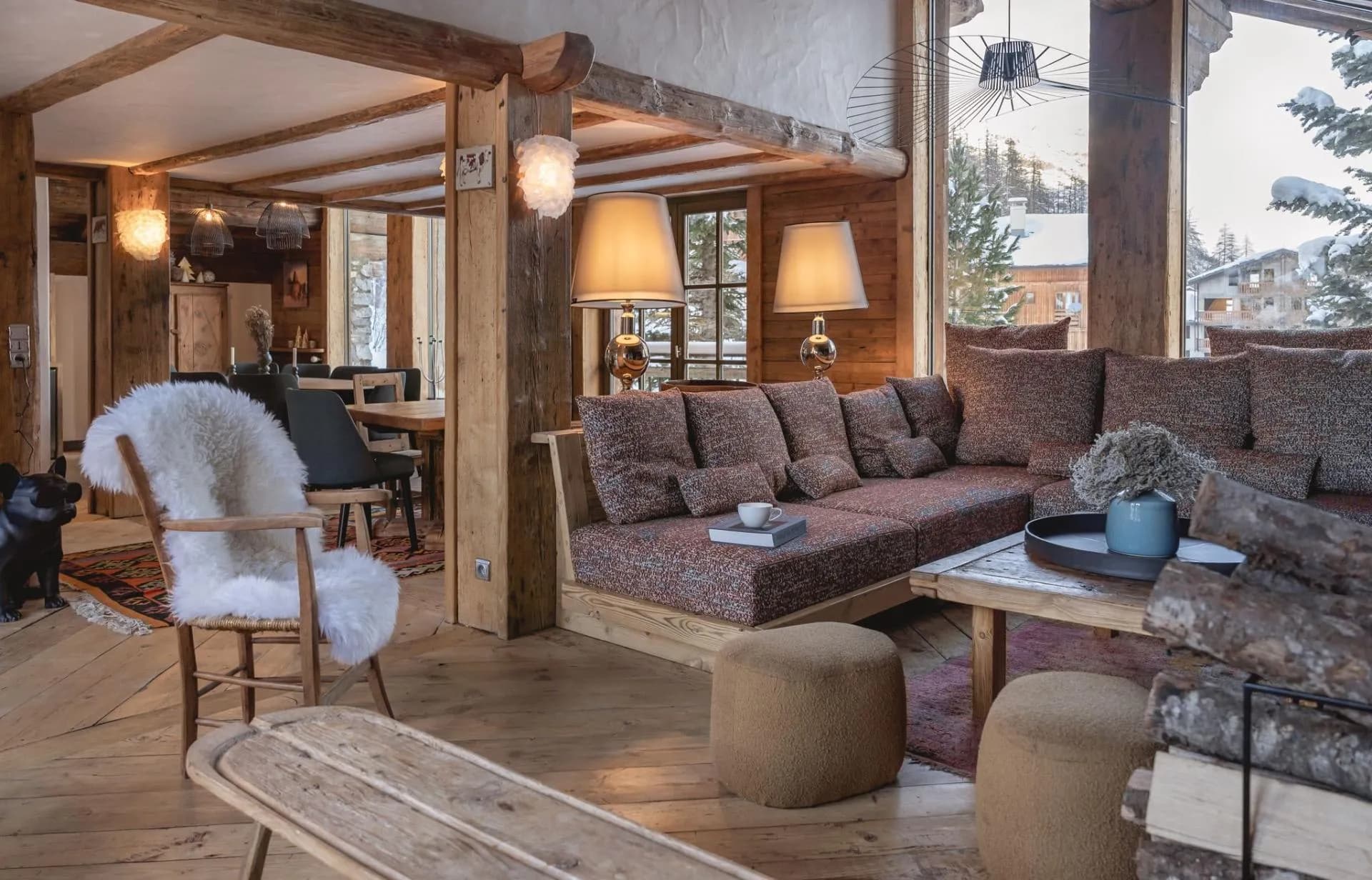 Fireside living room with sofas and broad windows