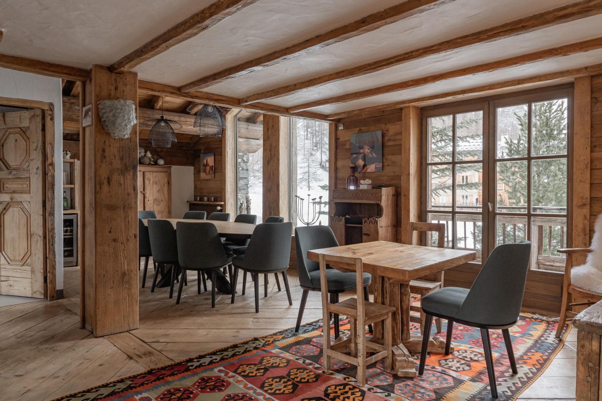 Dining area seating 10 with additional café table and balcony access