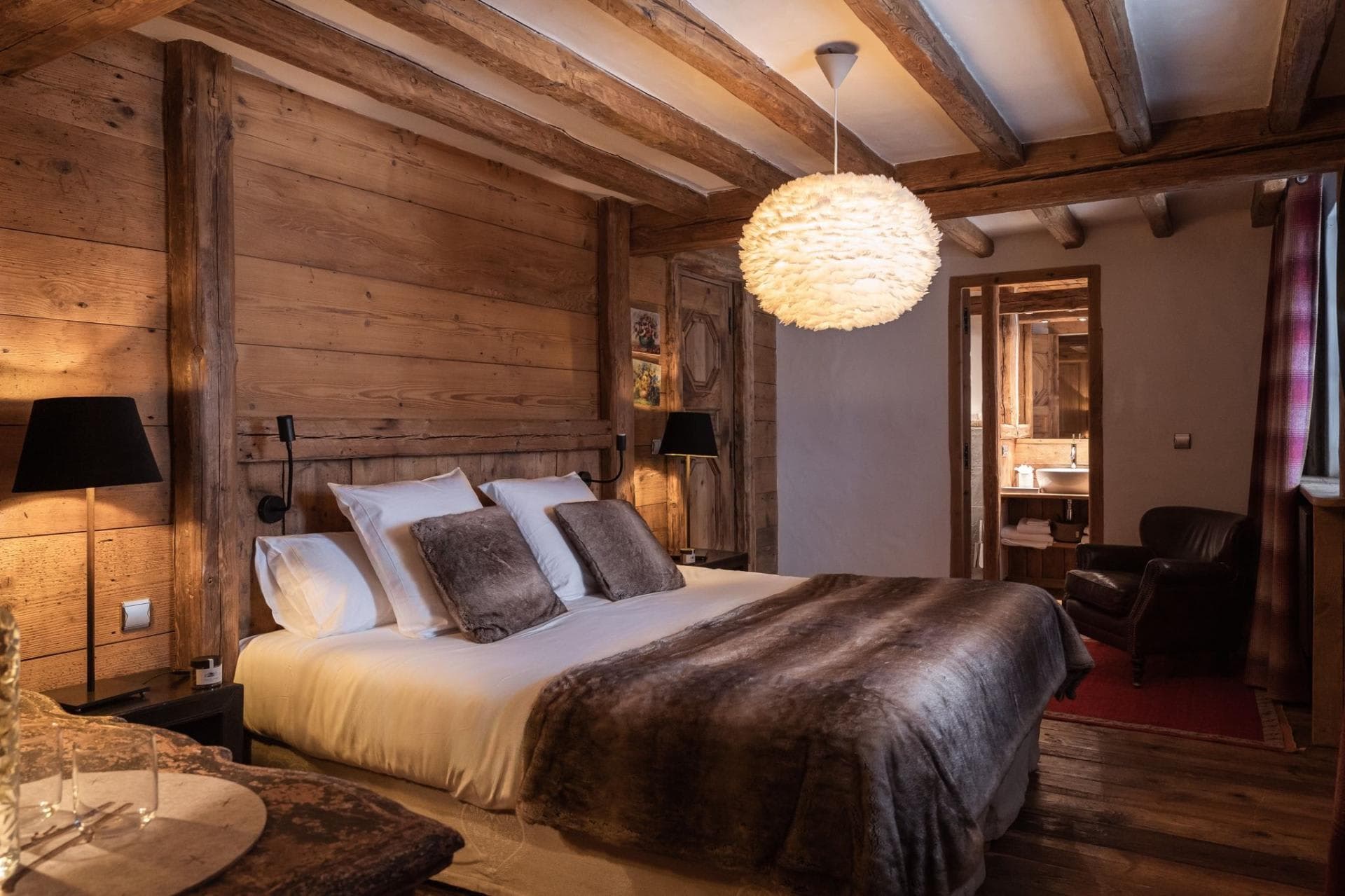 Primary bedroom with ensuite bathroom and original timber walls