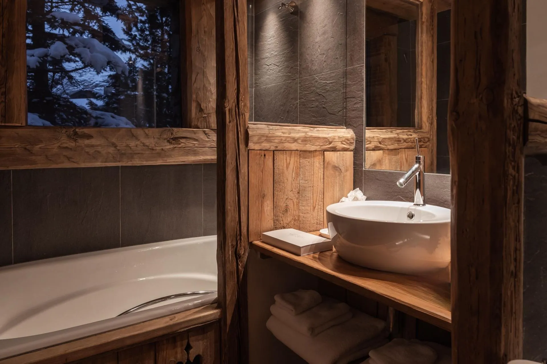 Bathroom with bathtub beside a window and vanity