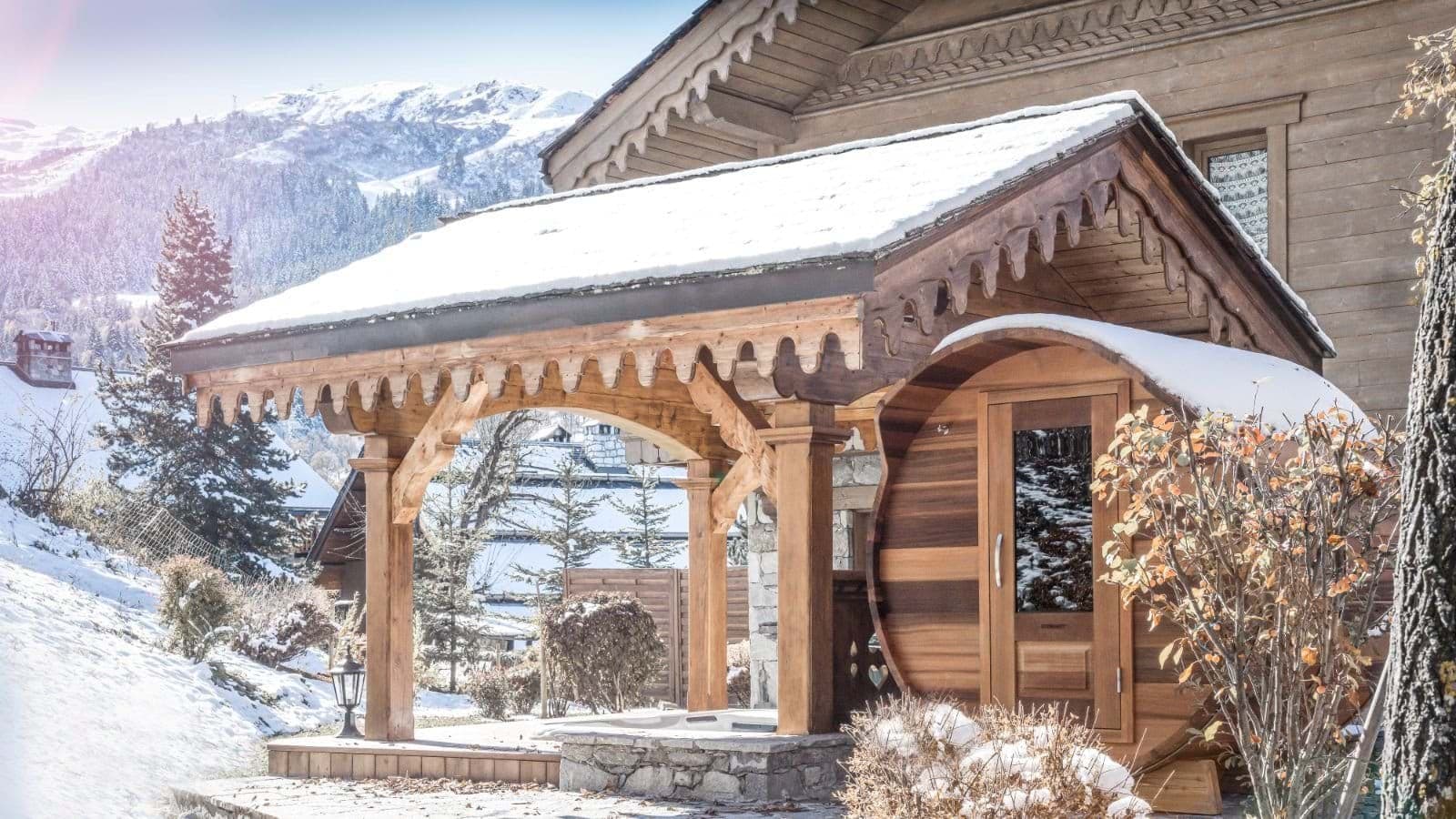 Covered outdoor barrel sauna with mountain views