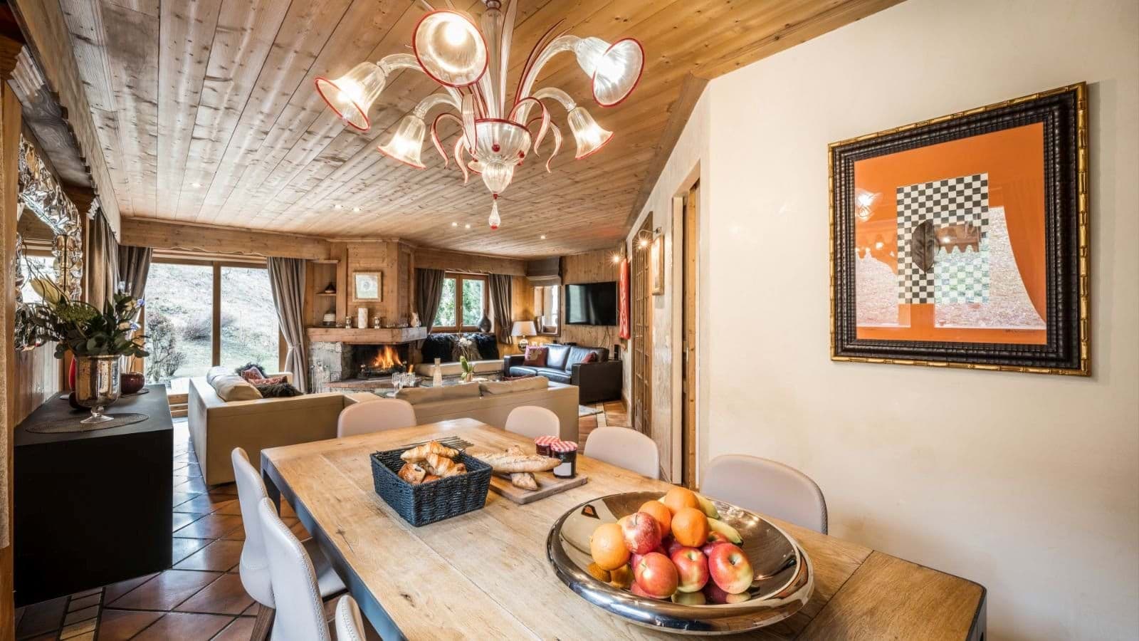 Open-plan dining area leading to living room with wood-burning fireplace