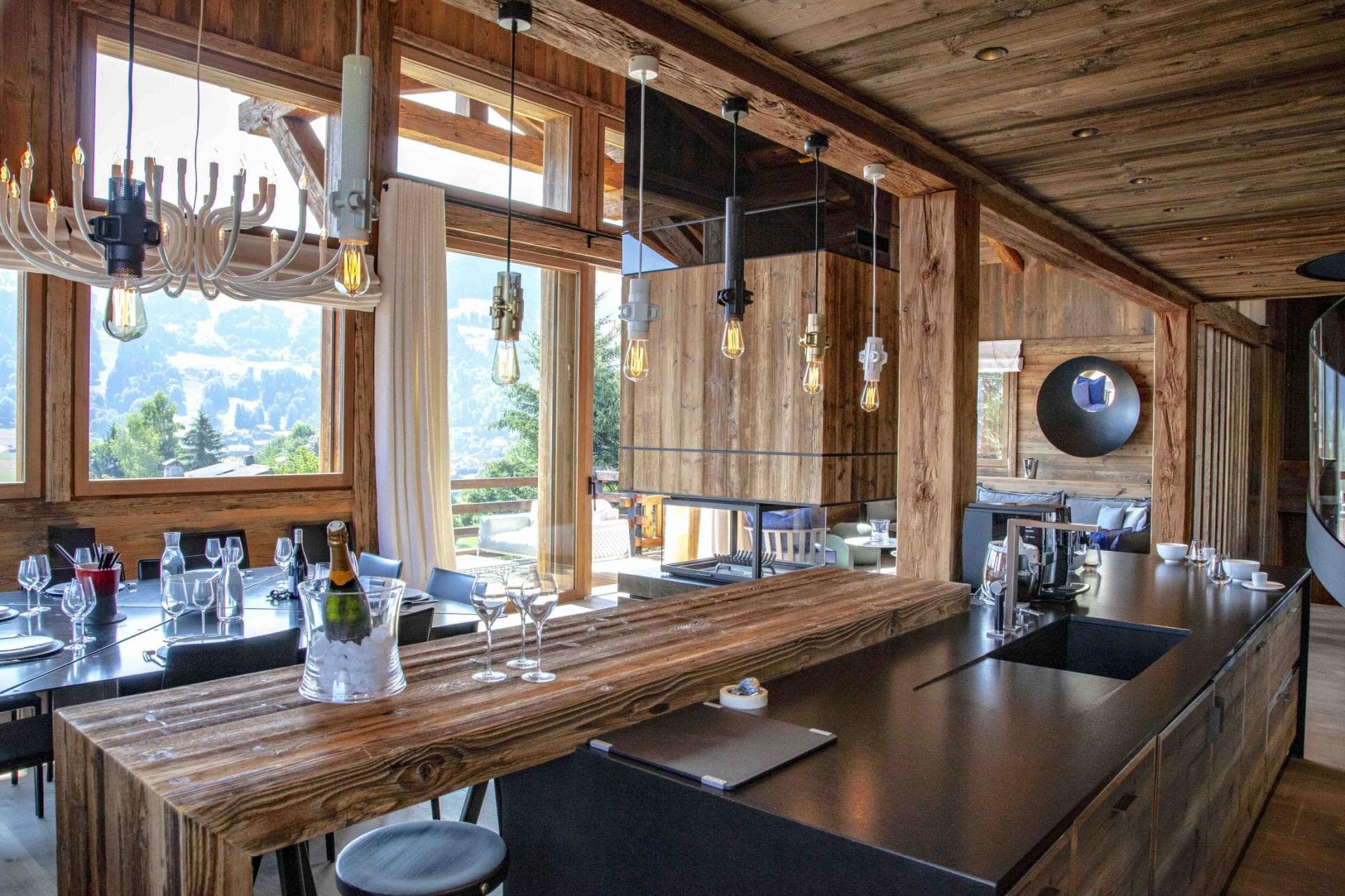Open-plan kitchen and dining area with 3-sided glass fireplace