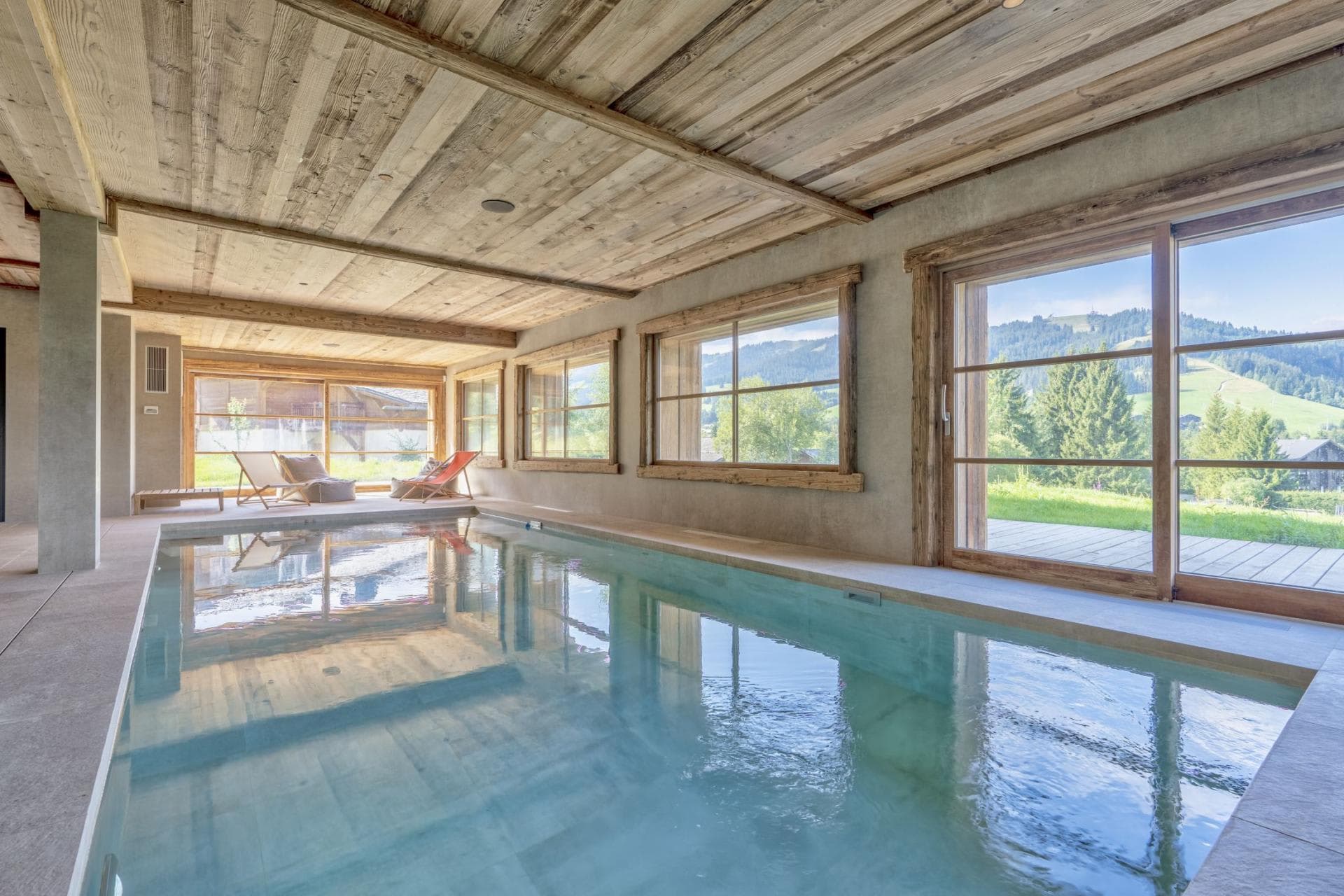 Indoor pool with garden access and mountain views